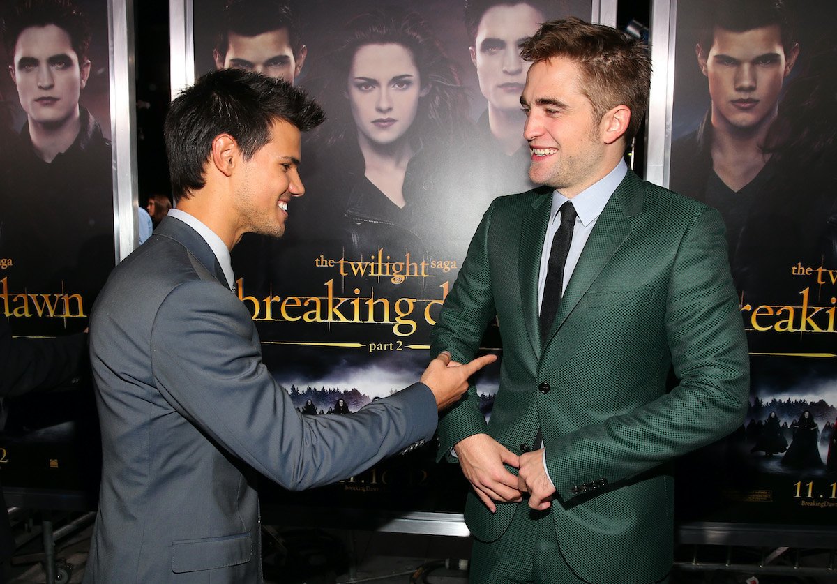 Twilight cast Taylor Lautner and Robert Pattinson laugh on the red carpet