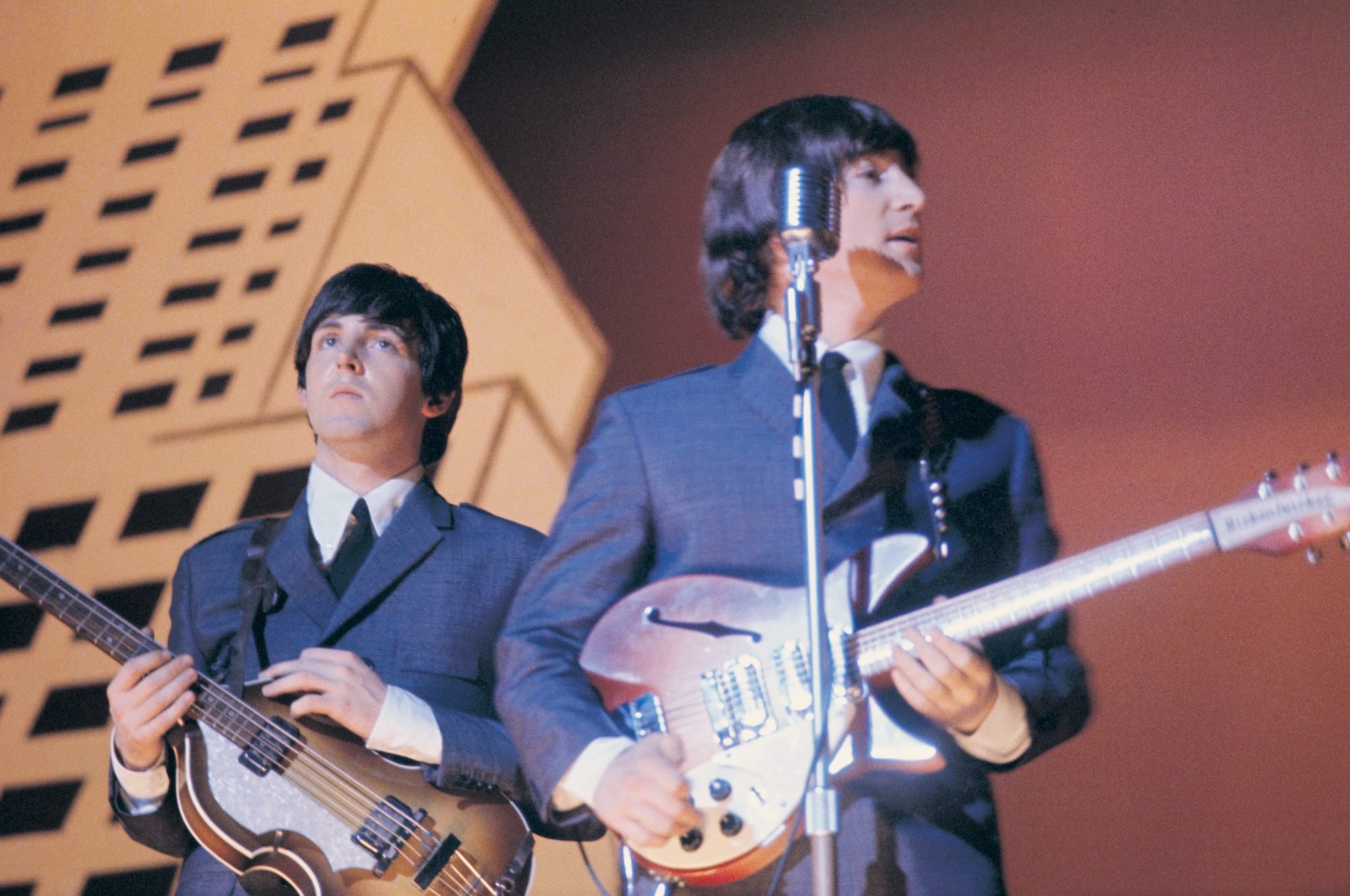 The Beatles songwriters Paul McCartney and John Lennon play guitar together