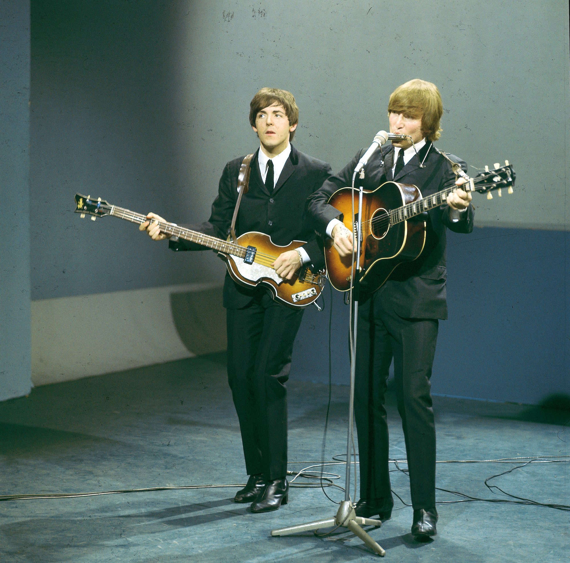 The Beatles' Paul McCartney and John Lennon play guitars together