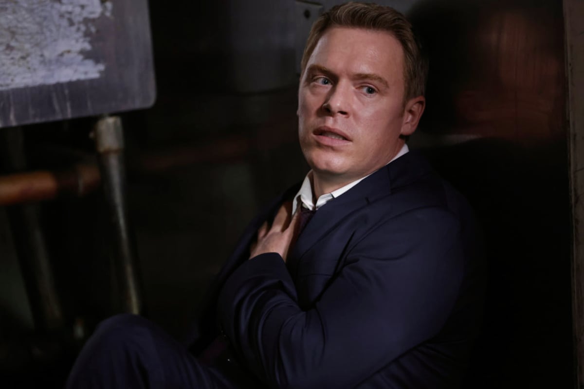 The Blacklist Episode 7 will focus on Donald Ressler. Diego Klattenhoff as Ressler holds his injured shoulder and leans against the wall.