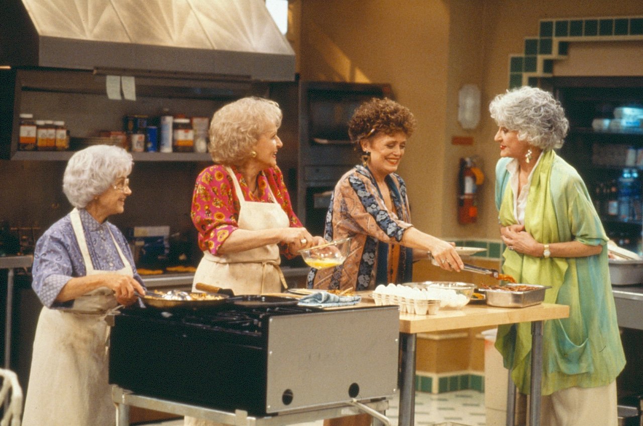 (from left) Estelle Getty (as Sophia Petrillo); Betty White (as Rose Nyland); Rue McClanahan (as Blanche Deveraux) and visiting guest star Bea Arthur (as Dorothy Zbornak) cook together in a kitchen in 'The Golden Palace'