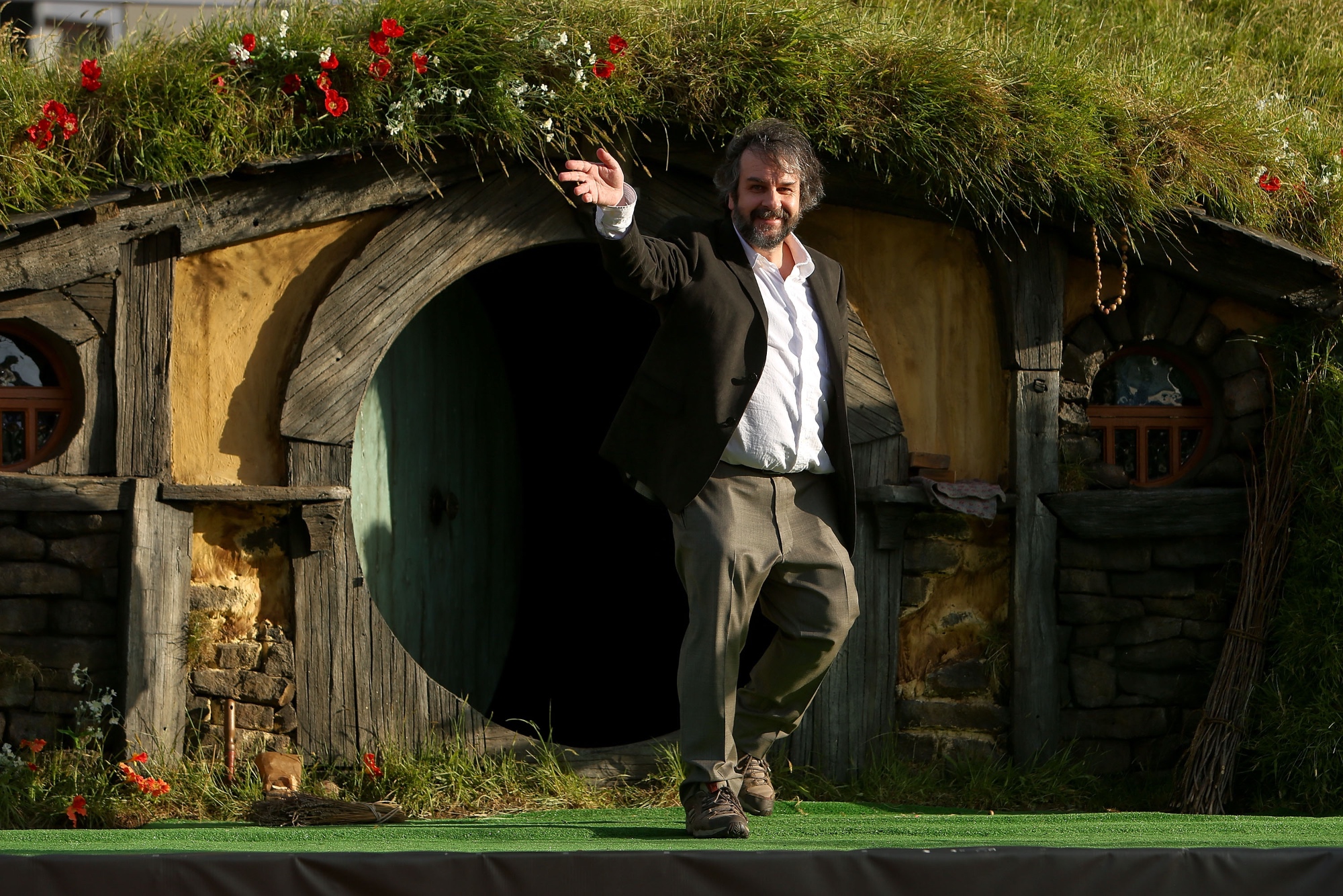 'The Lord of the Rings' Peter Jackson waving in front of a Hobbit home in The Shire