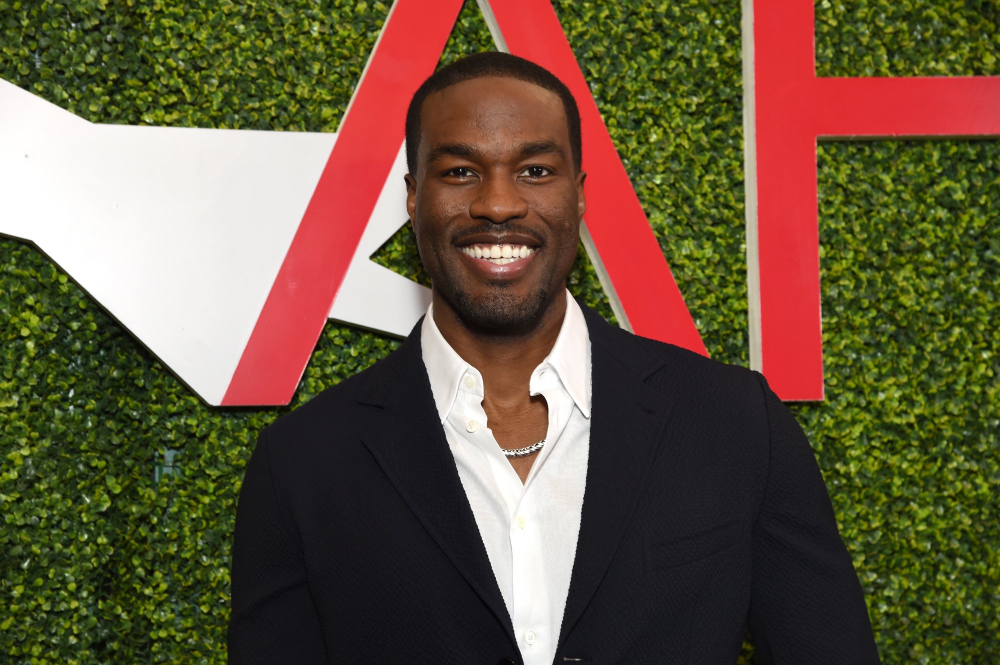 'The Matrix Resurrections' actor Yahya Abdul-Mateen II with dress shirt in front of AFI logo