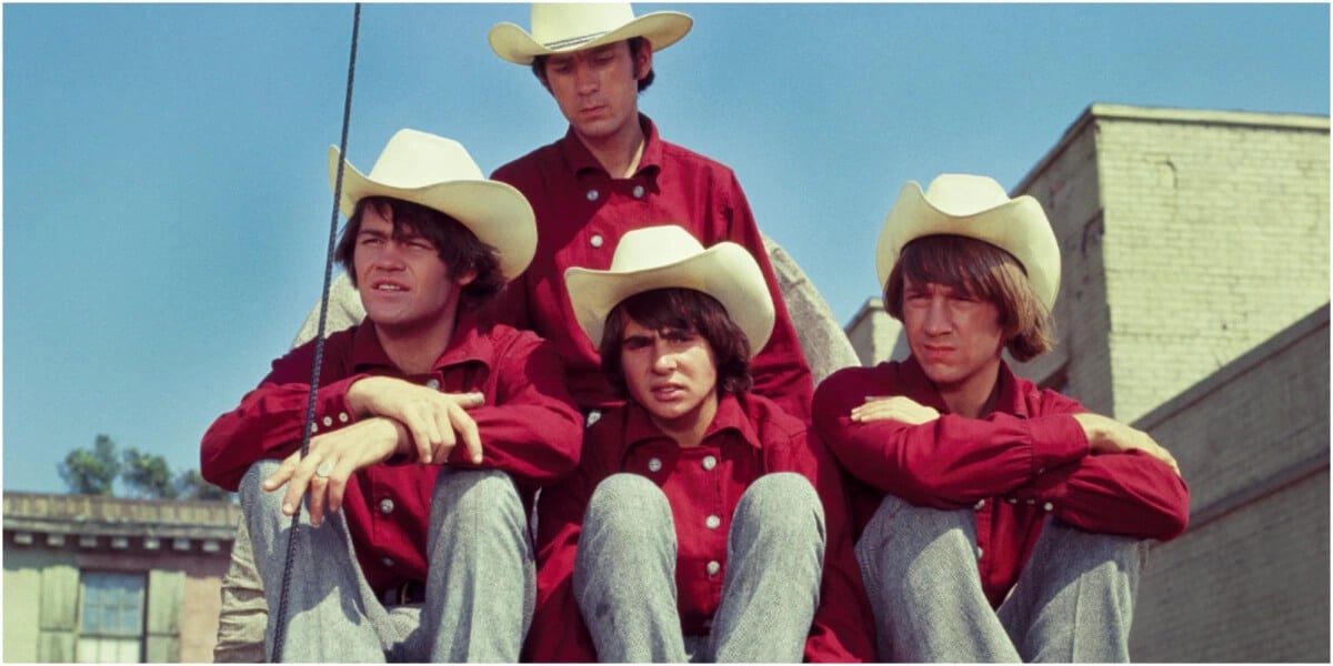 The Monkees cast includes Davy Jones, Mike Nesmith, Mickey Dolenz, and Peter Tork, wearing red shirts and white cowboy hats. 