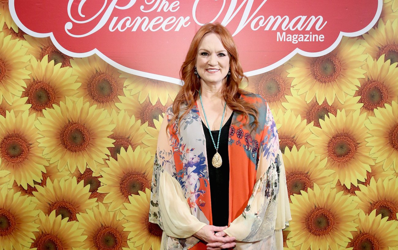 Ree Drummond smiles as she stands in front of a 'Pioneer Woman magazine' sign