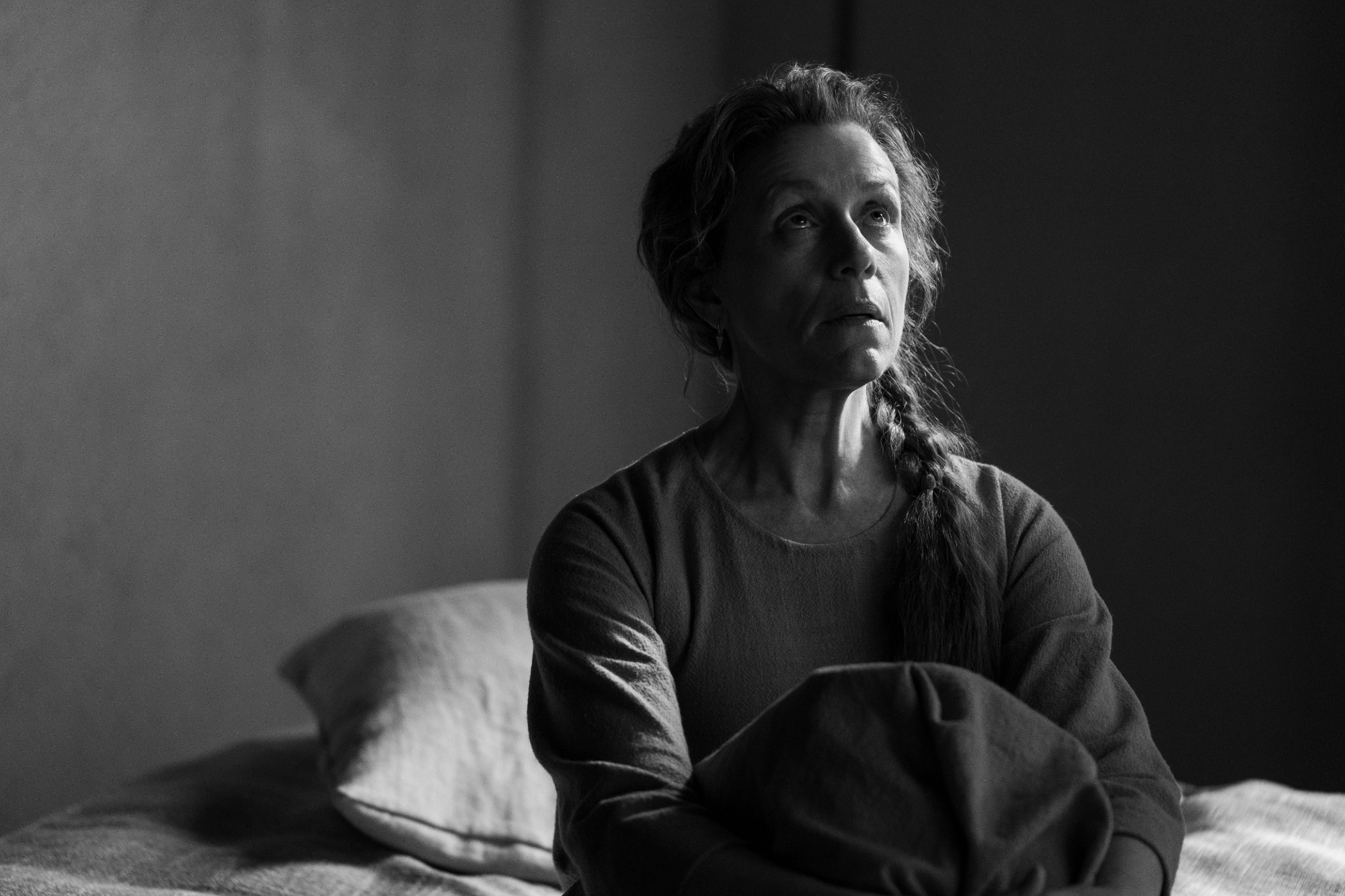 'The Tragedy of Macbeth' review Frances McDormand as Lady Macbeth sitting on a bed looking up
