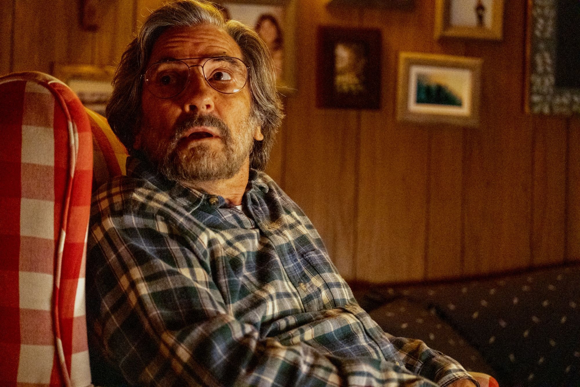 'This Is Us' Season 6 star Griffin Dunne, in character as Nicky, wears a blue plaid shirt and glasses.