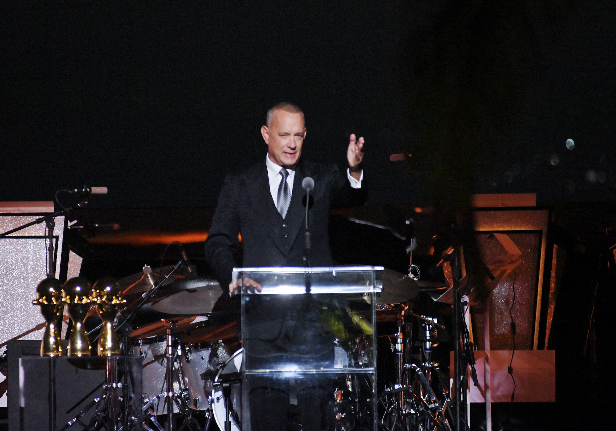 Tom Hanks speaks at a podium