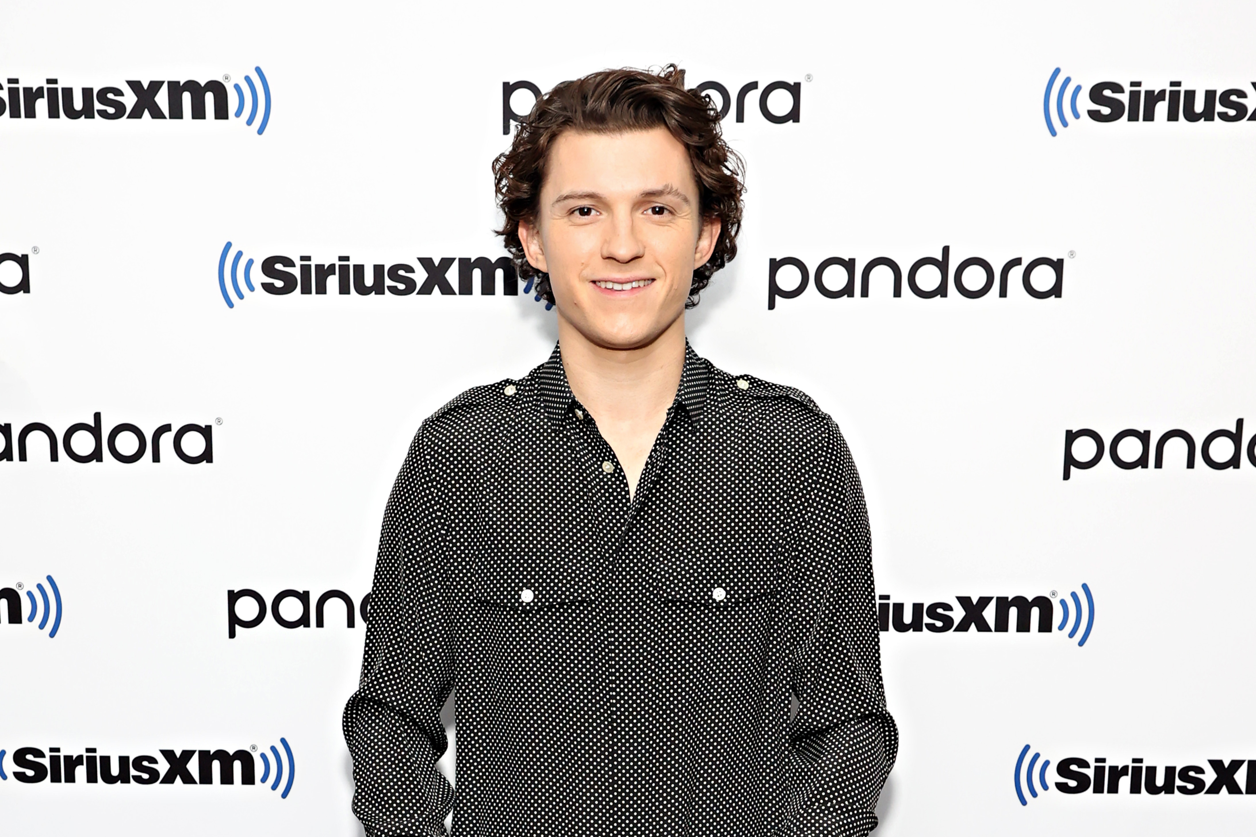 'Spider-Man: No Way Home' star Tom Holland wears a black button-up long-sleeved shirt with white polka dots.