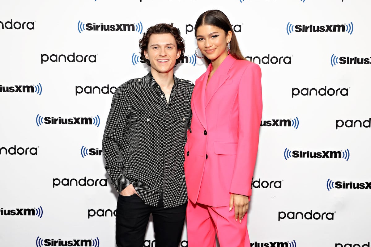 Tom Holland and Zendaya pose together at an event.