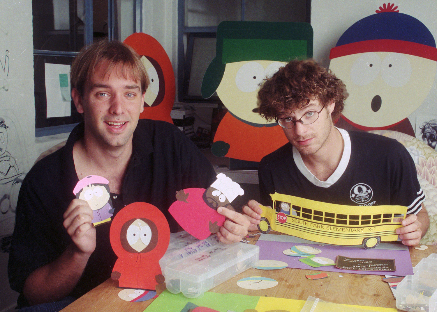 Trey Parker holds Isaac Hayes' 'South Park' character Chef and Wendy, while Matt Stone holds the school bus