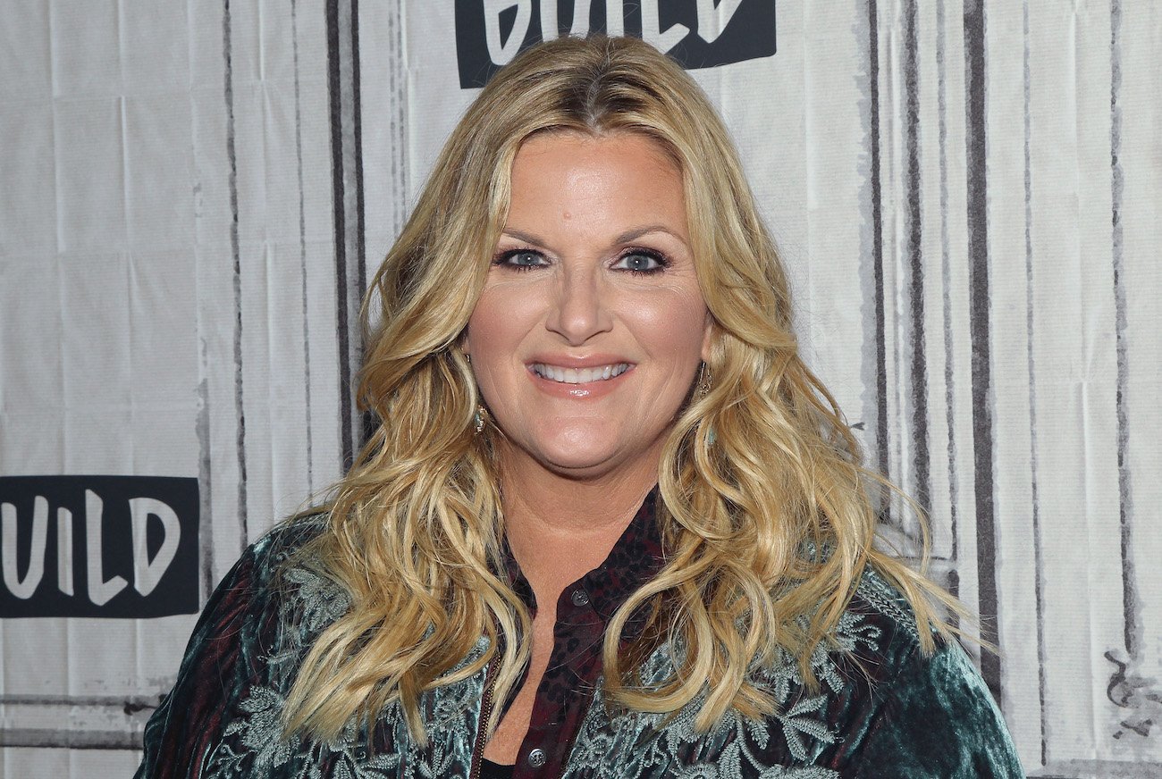 Trisha Yearwood smiles wearing a blue shirt