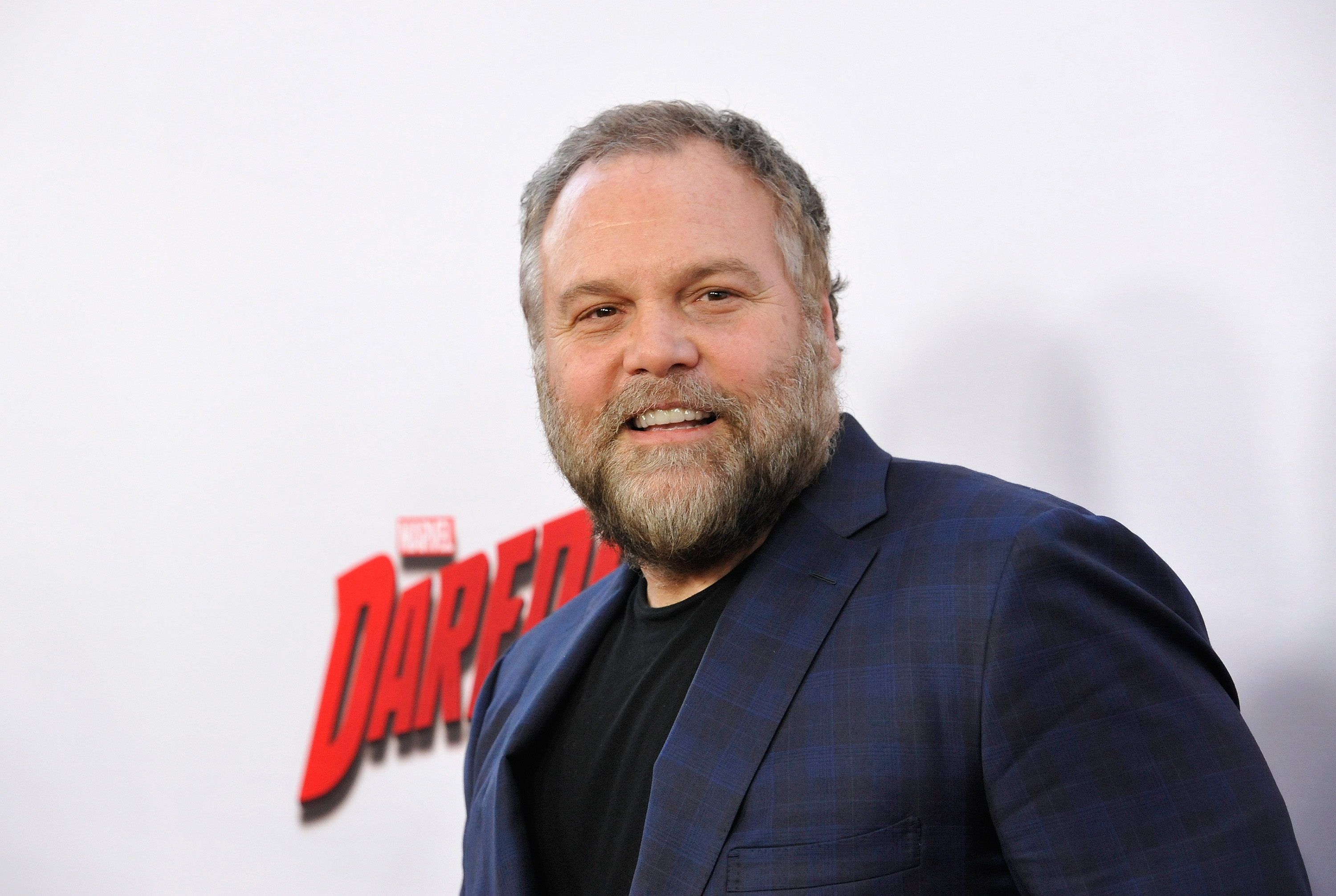'Hawkeye' actor Vincent D'Onofrio, who plays Kingpin, wears a blue suit jacket over a black shirt.