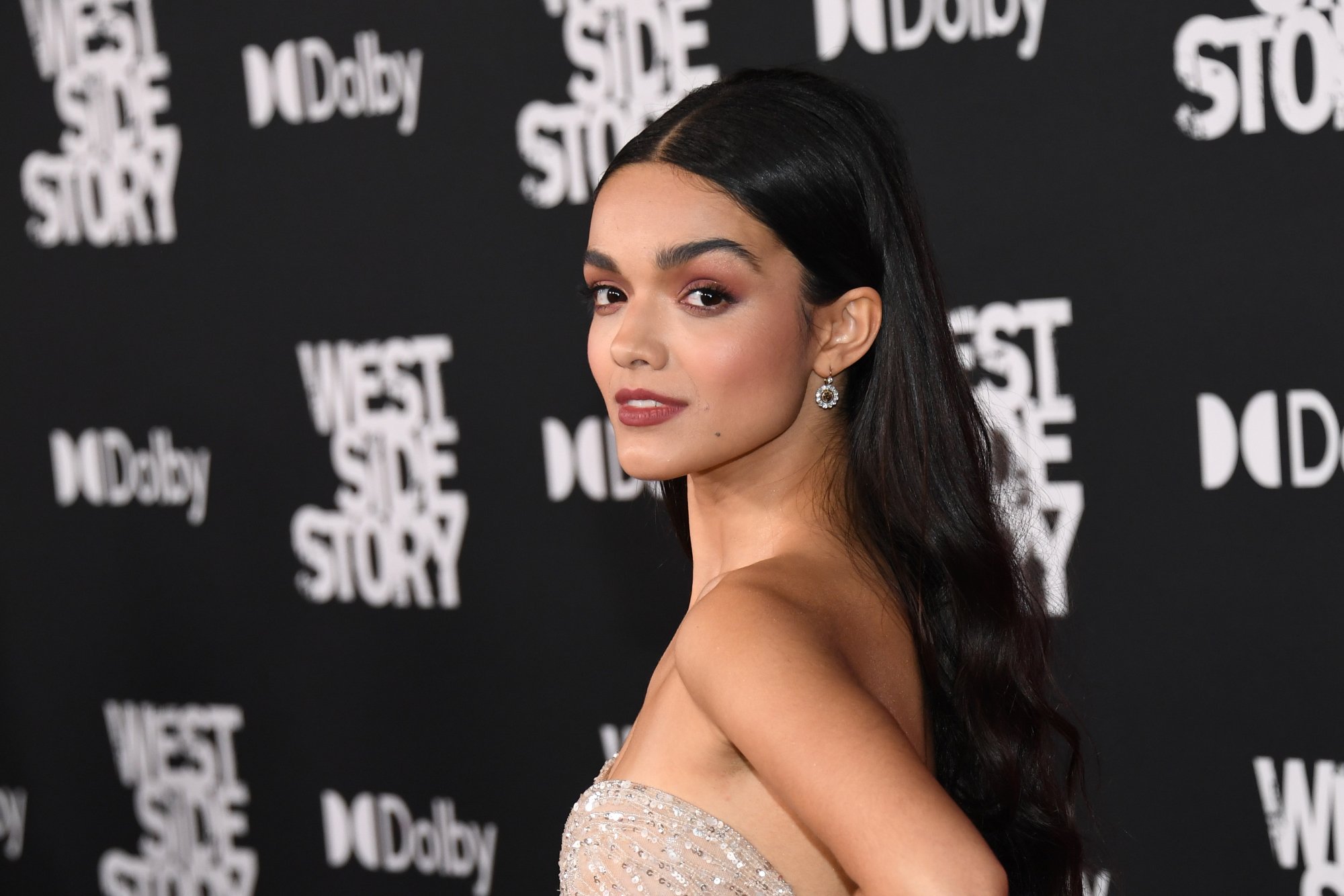'West Side Story' Rachel Zegler looking to the side in front of the 'West Side Story' step and repeat