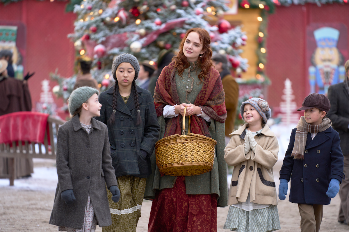 LIllian holding a basket and surrounded by orphans in 'When Hope Calls' Season 2