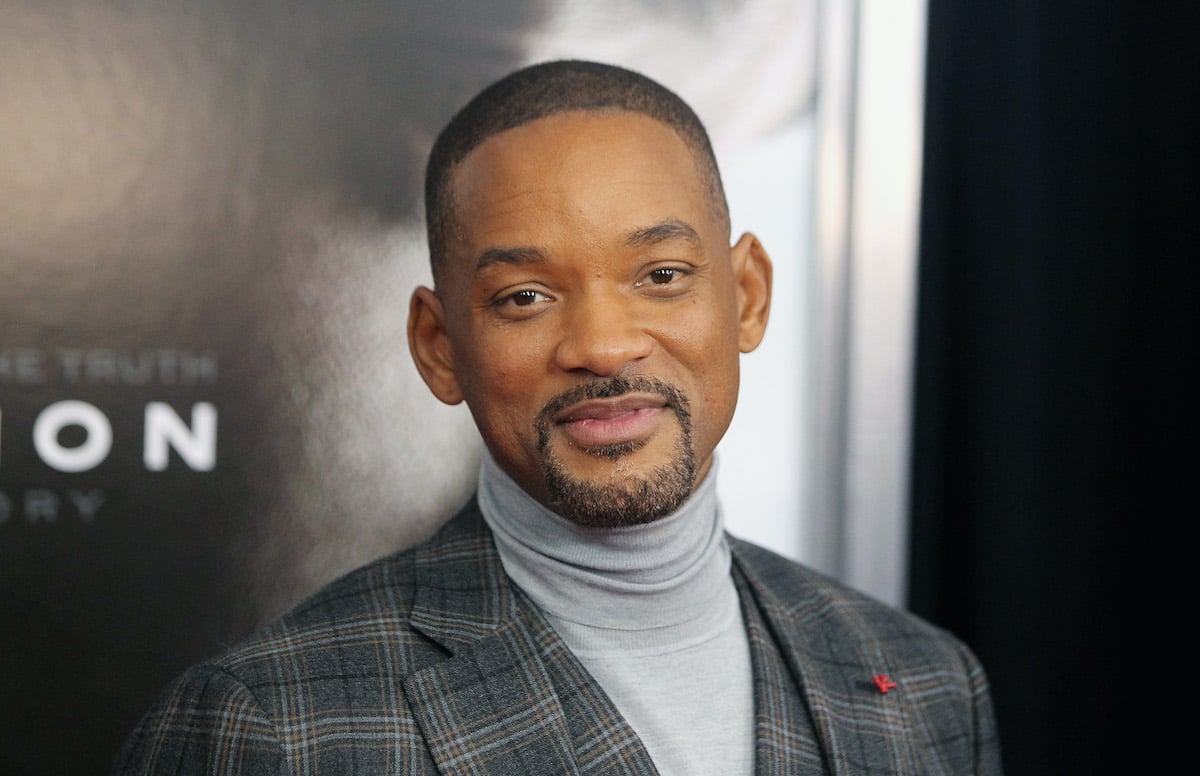 Will Smith smiling in front of a black background