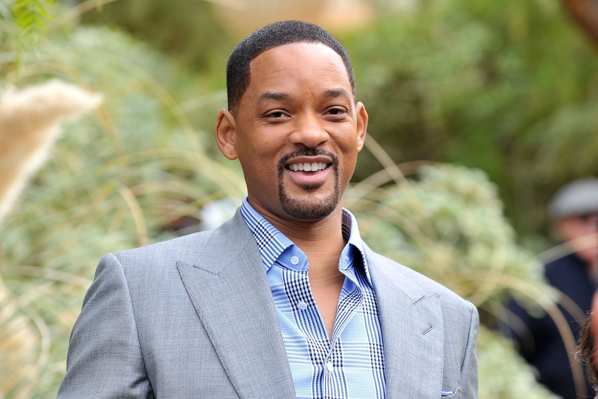 Will Smith in article about turning down 'Django Unchained' wearing blue and grey in front of greenery