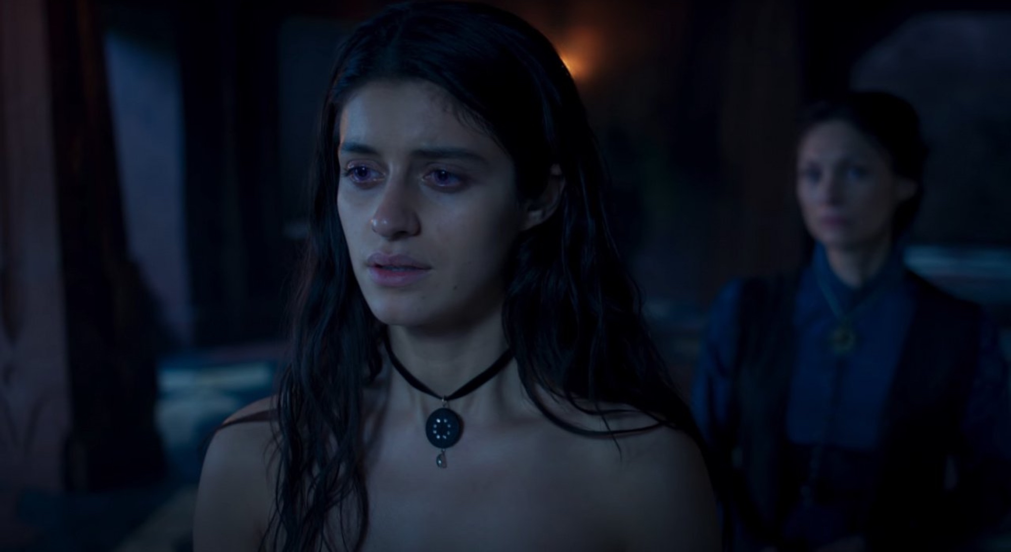 Yennefer and Tissaia in 'The Witcher' Season 2 in a dark room crying.