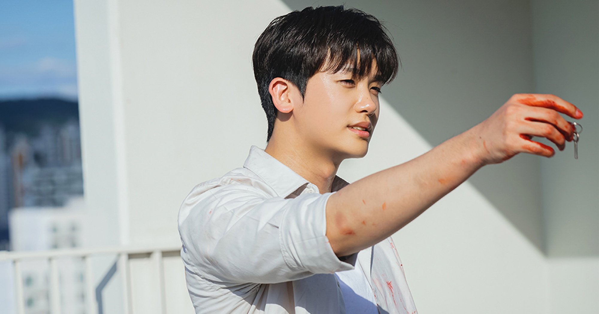 Yi-hyun from 'Happiness' K-drama with bloody shirt and handcuff key.