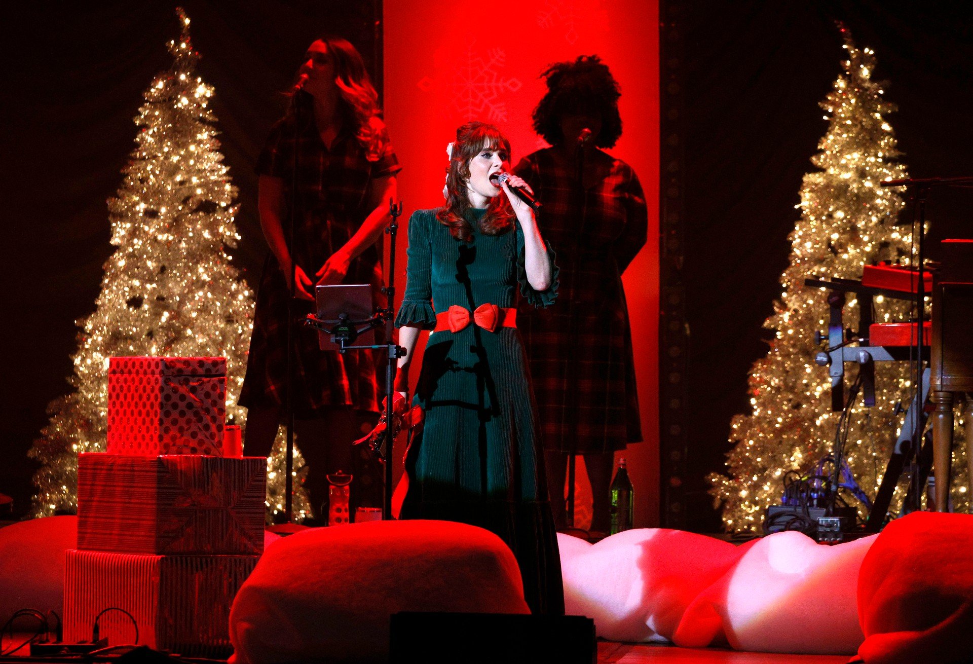 Zooey Deschanel sings at a Christmas celebration
