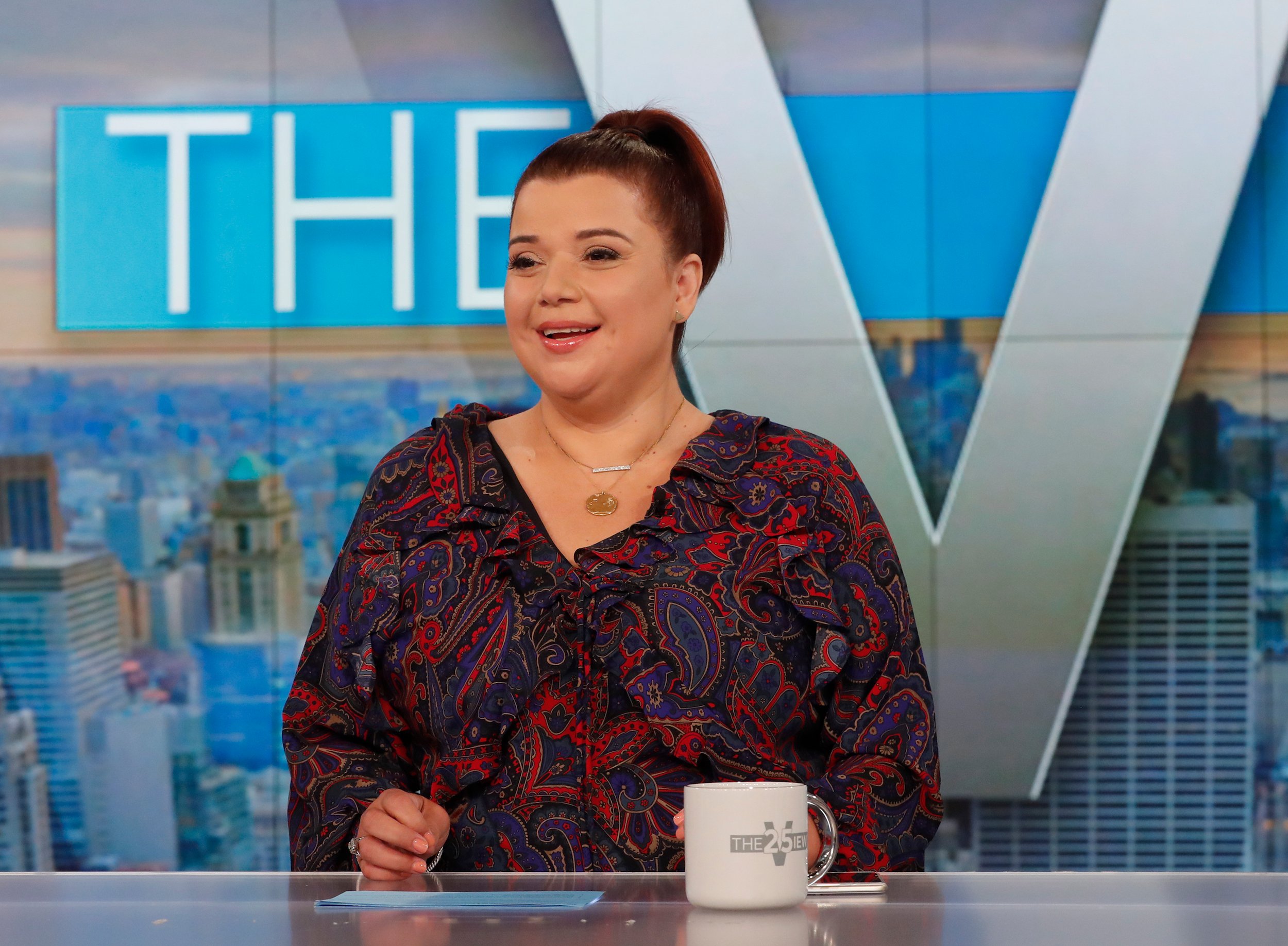 Ana Navarro smiling on the set of 'The View' wearing a loose top