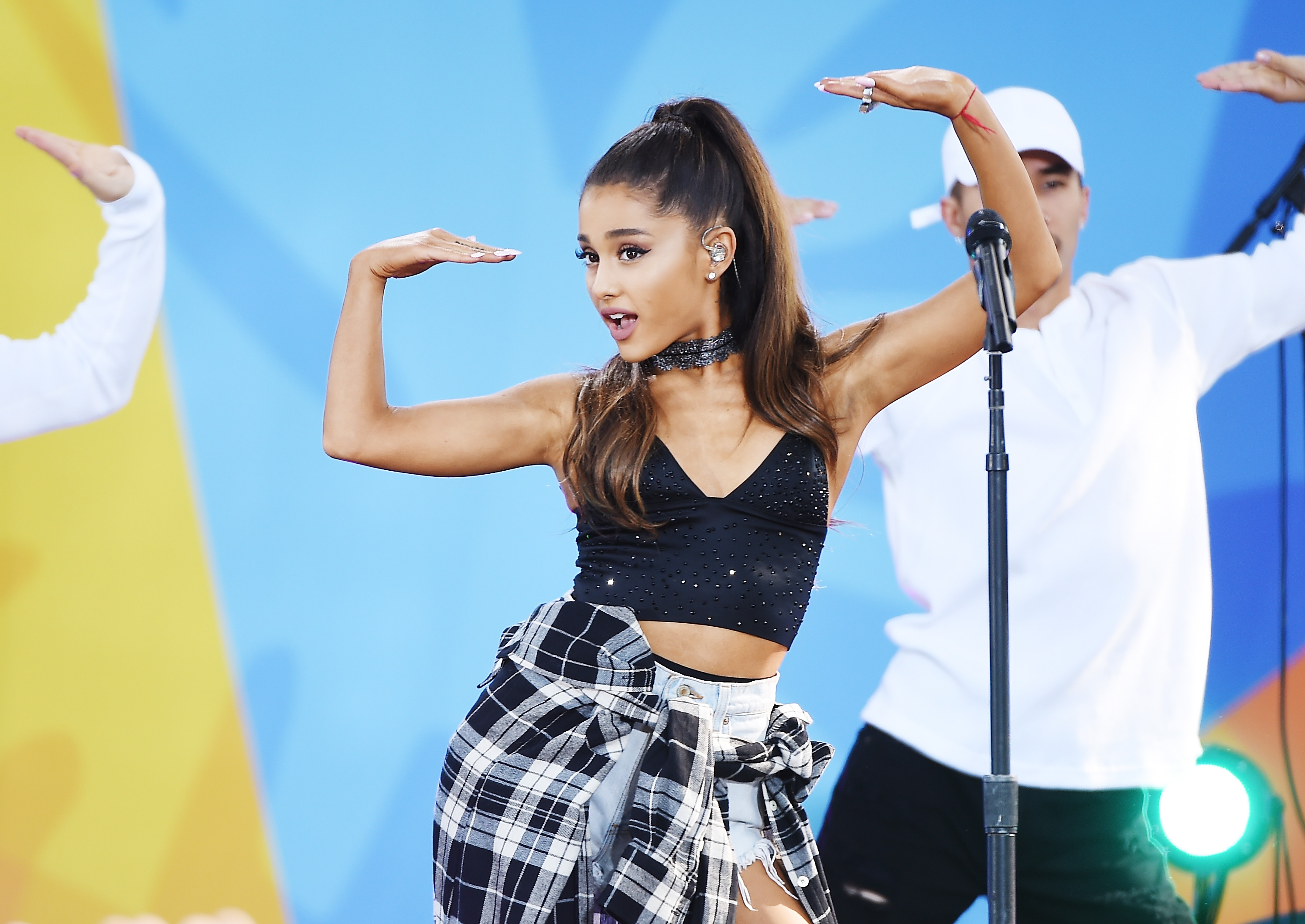 Ariana Grande raising her hands
