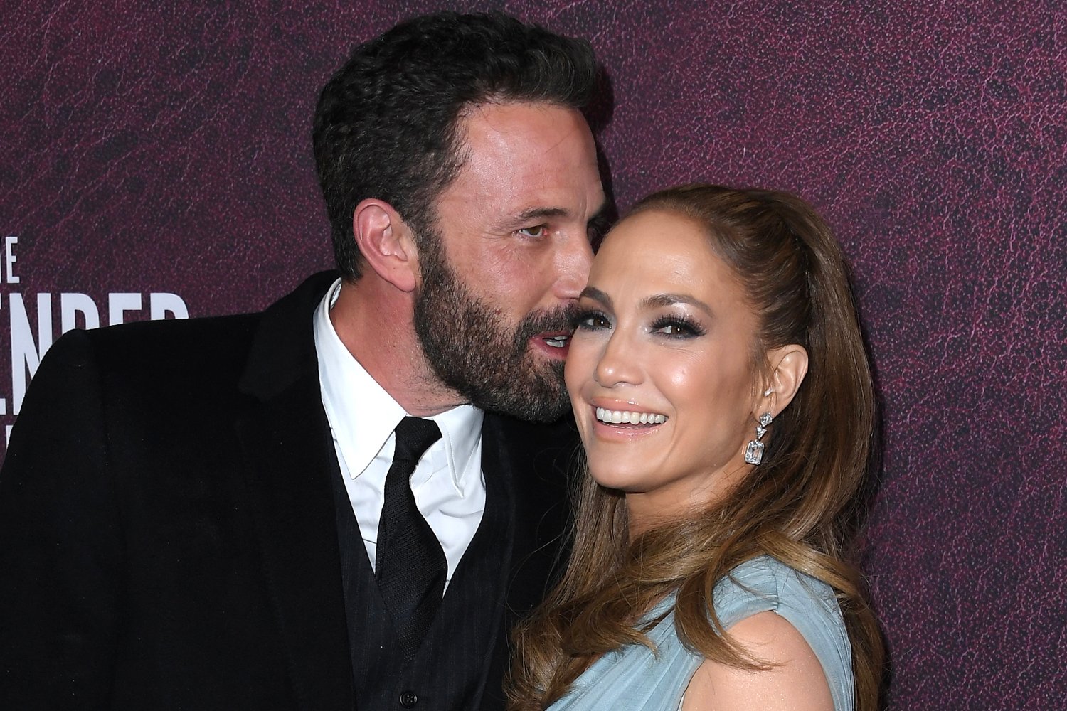 Ben Affleck kissing Jennifer Lopez on the cheek while the latter smiles