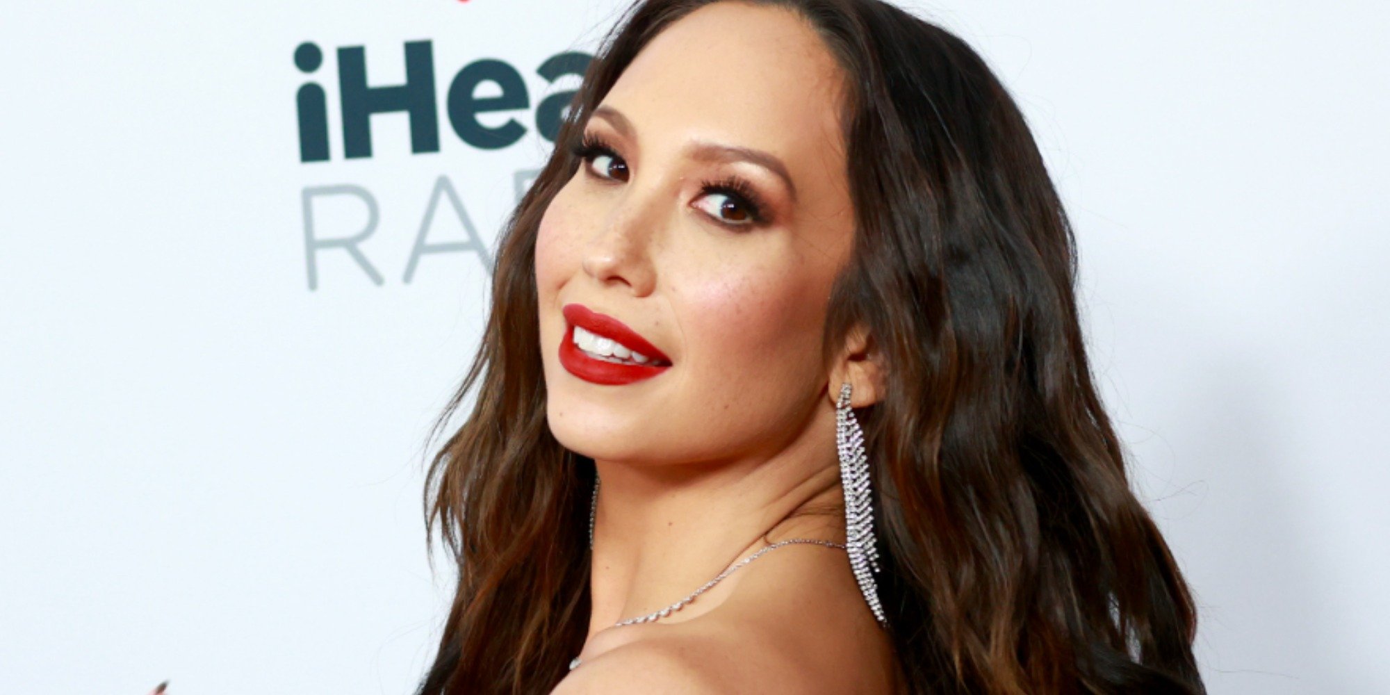 Cheryl Burke poses on the red carpet at Jingle Ball 2021.