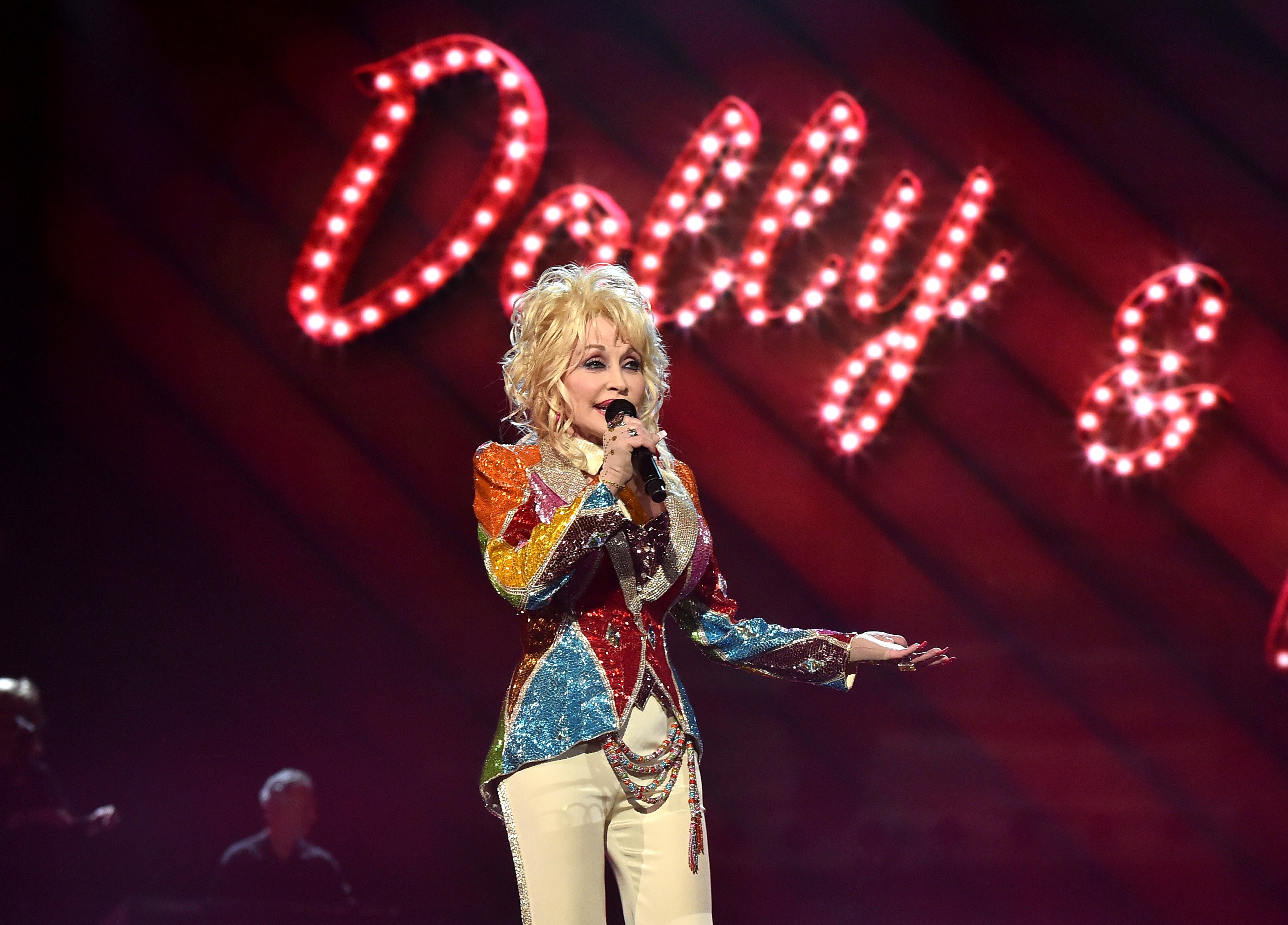 Dolly Parton in her colorful jacket