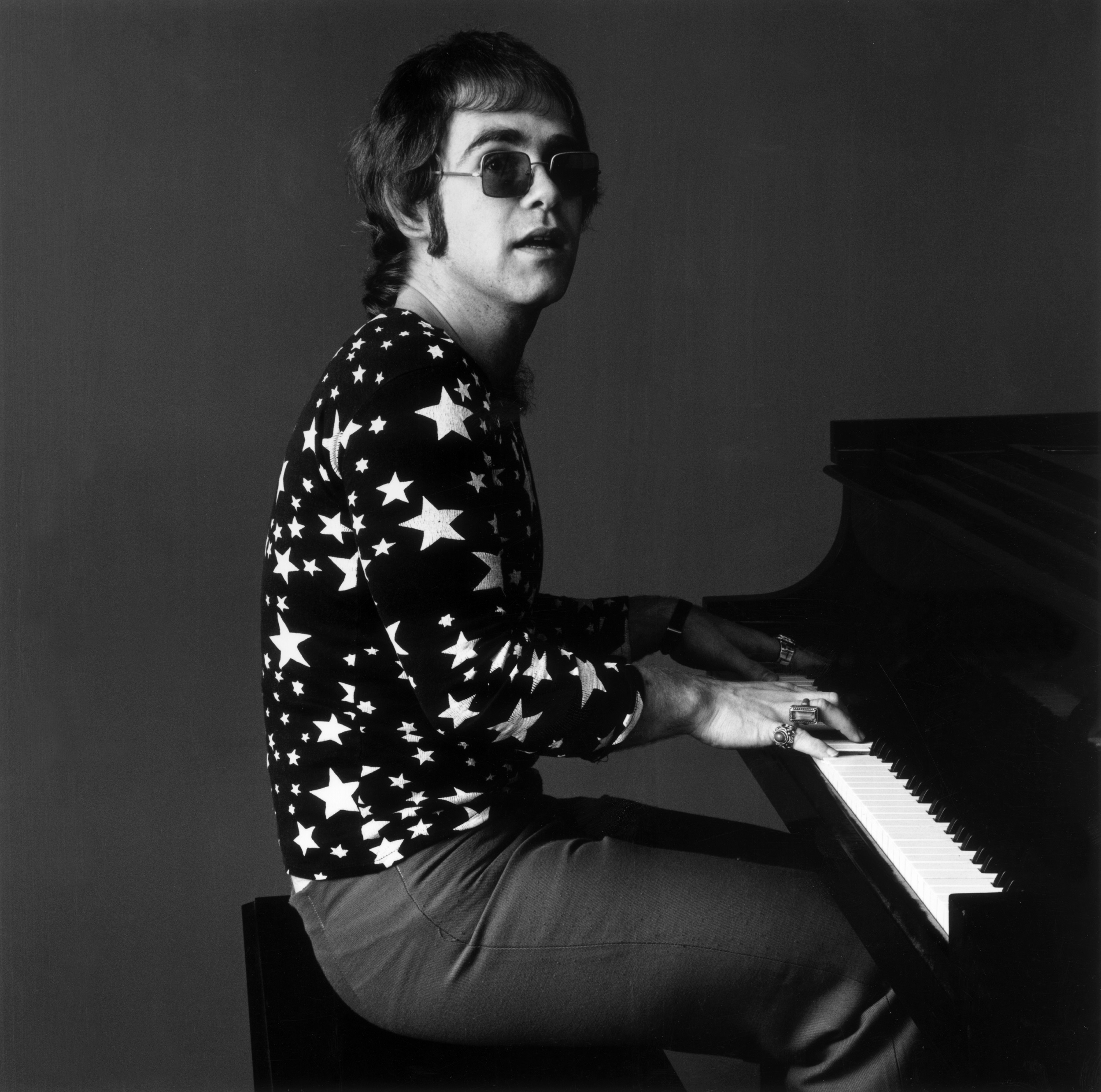 Elton John at a piano