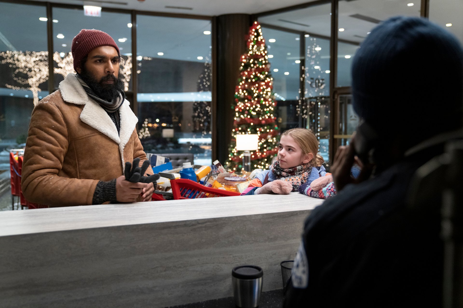 Himesh Patel and Matilda Lawler standing at a counter in 'Station Eleven'