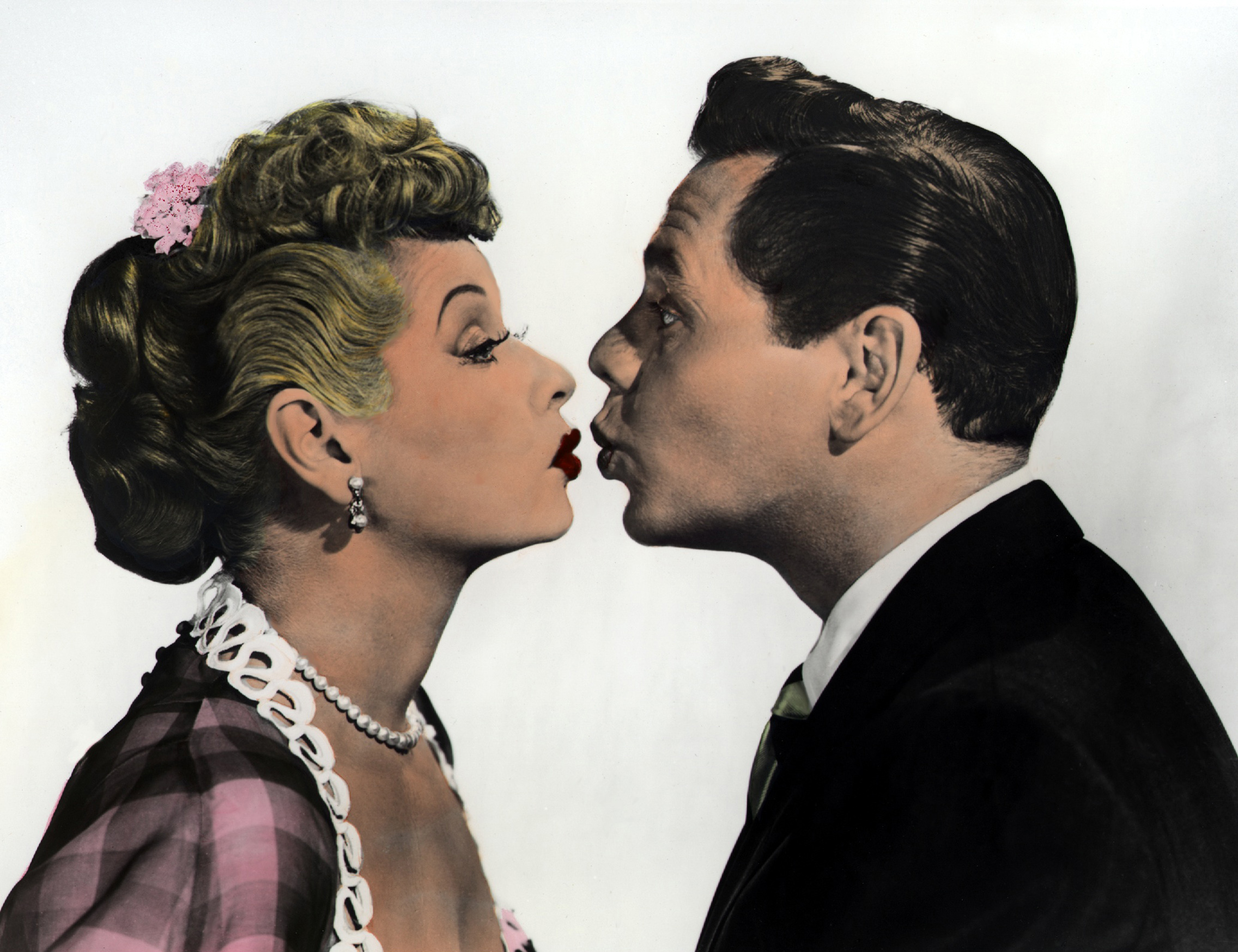 'I Love Lucy' stars Lucille Ball and Desi Arnaz kissing in a promotional image for 'The Long, Long Trailer'