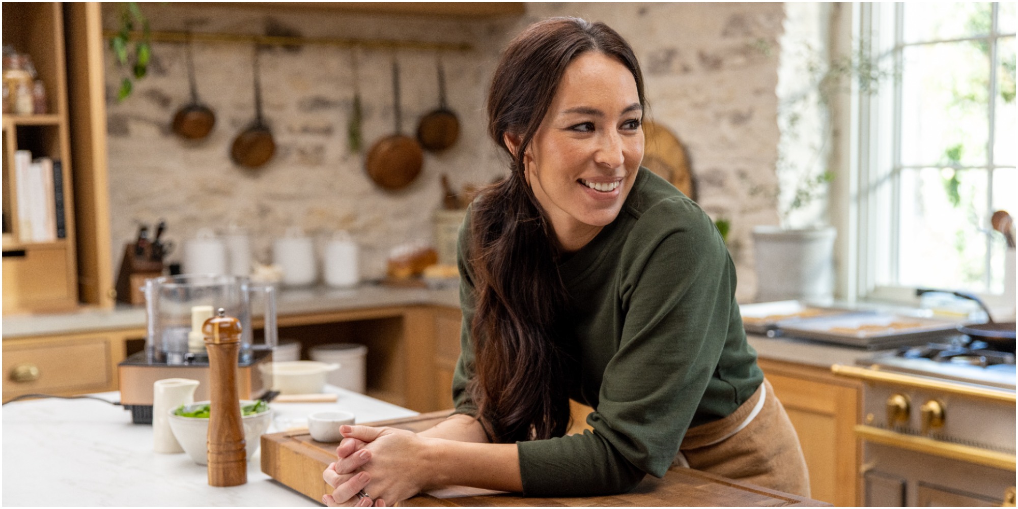 Joanna Gaines cooks in the kitchen of her discovery+ show.