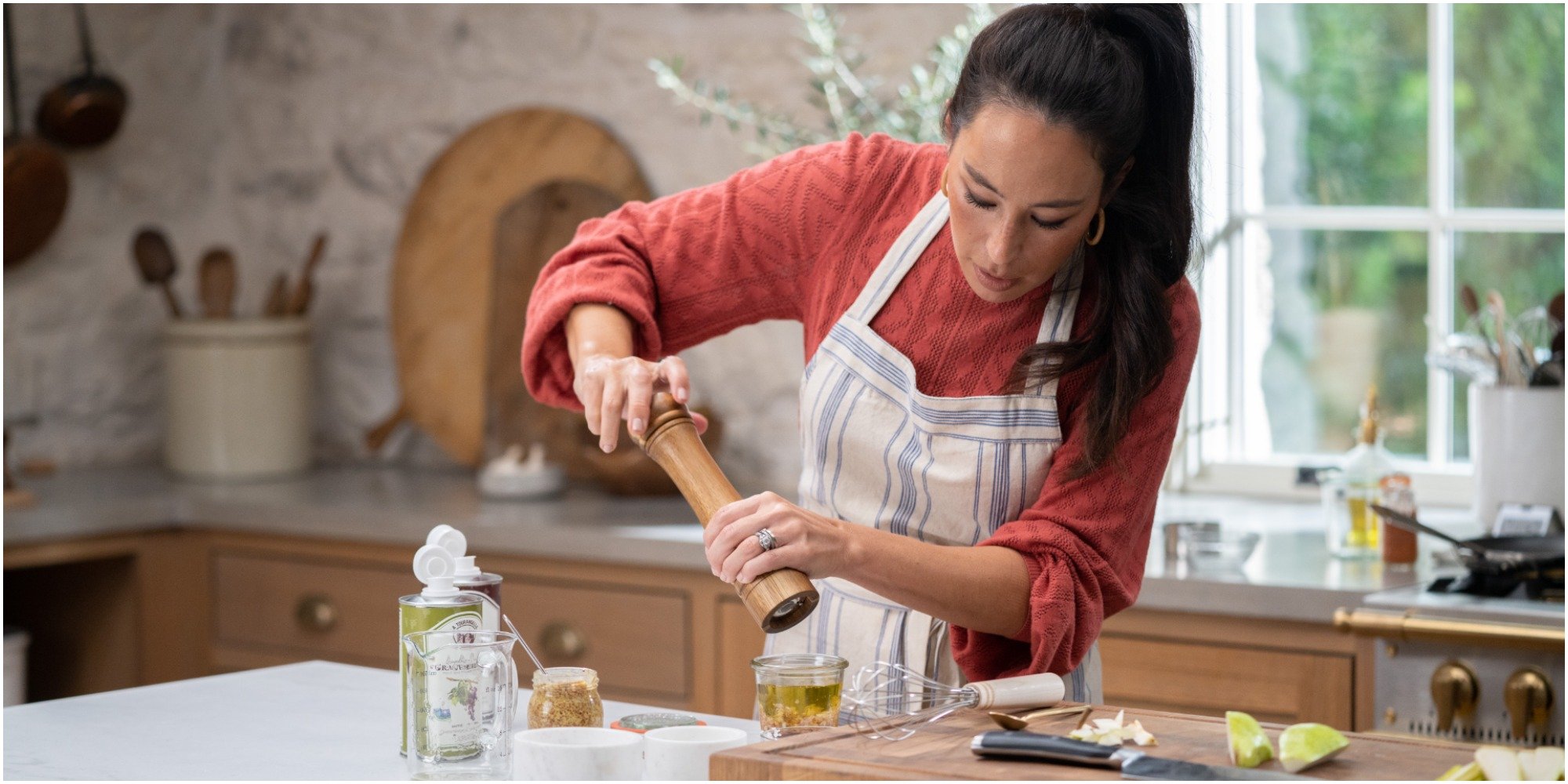 Joanna Gaines cooks in the kitchen of her discovery+ show.