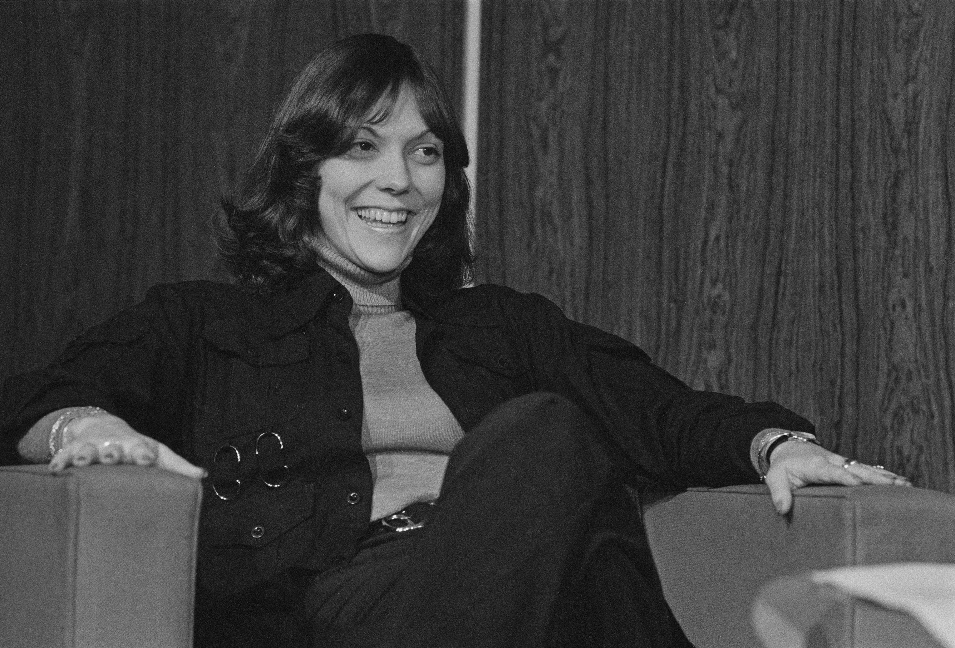 The Carpenters' Karen Carpenter sitting in a chair