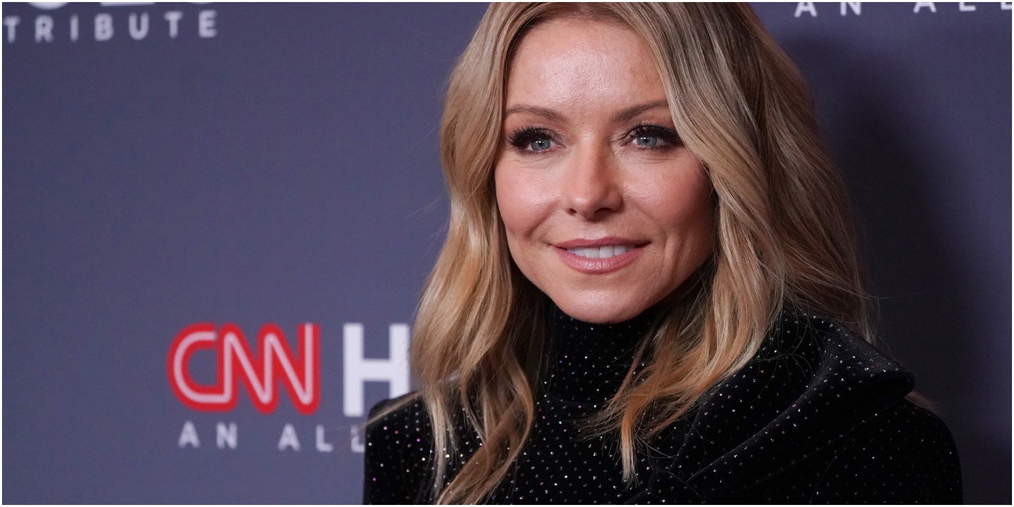 Kelly Ripa wears a black dress at a press event.