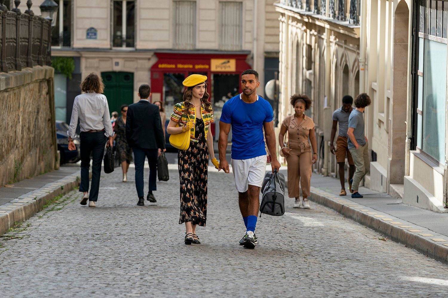 Lily Collins as Emily and Lucien Laviscount as Alfie in Emily in Paris Season 2
