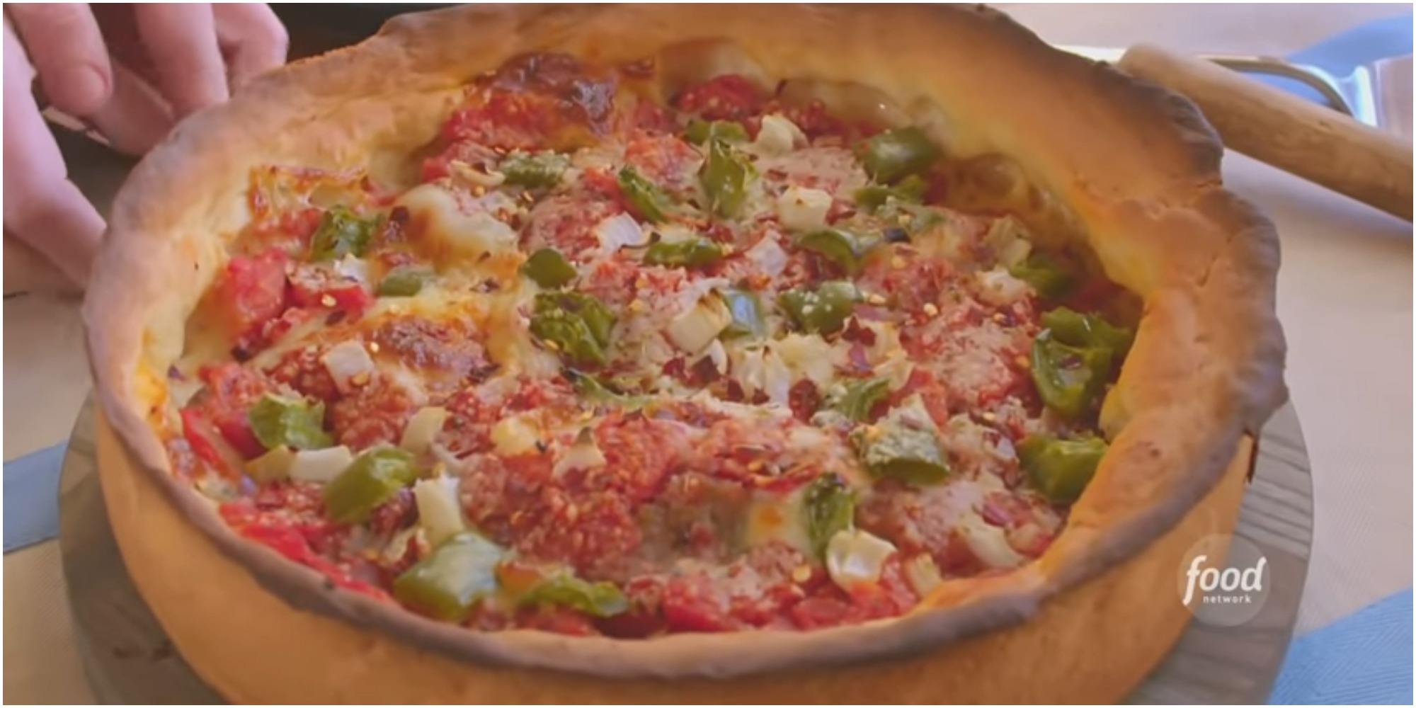 Molly Yeh shows off her sausage deep dish pizza on Girl Meets Farm.