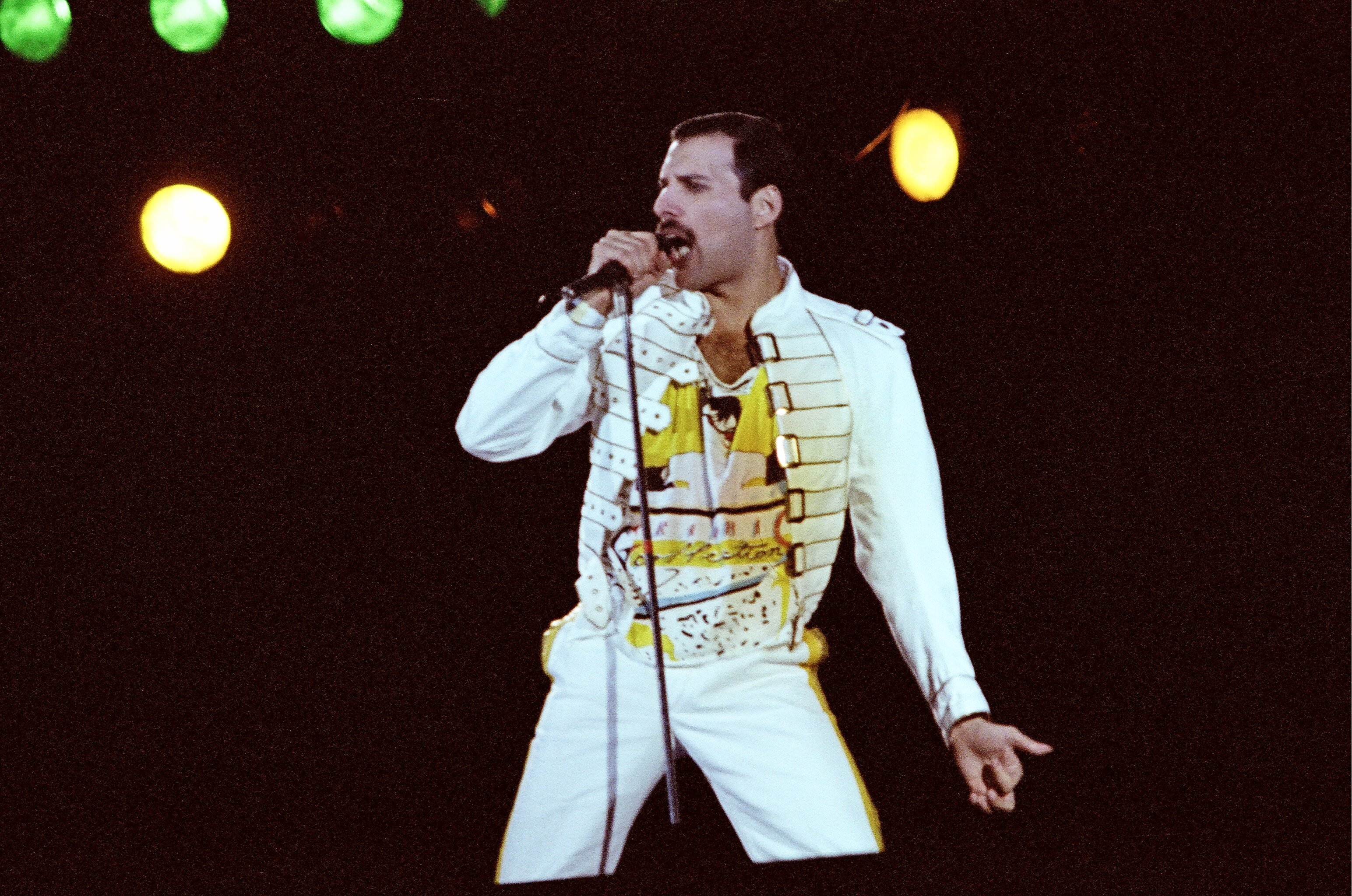 Freddie Mercury, the singer who performed vocals on Queen's Christmas song "Thank God It's Christmas," with a microphone