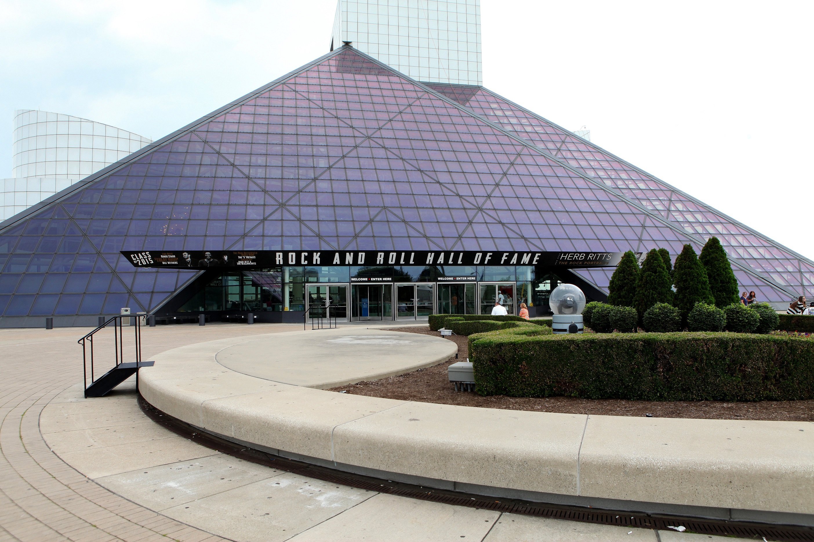 The Rock & Roll Hall of Fame and Museum with bushes in the front