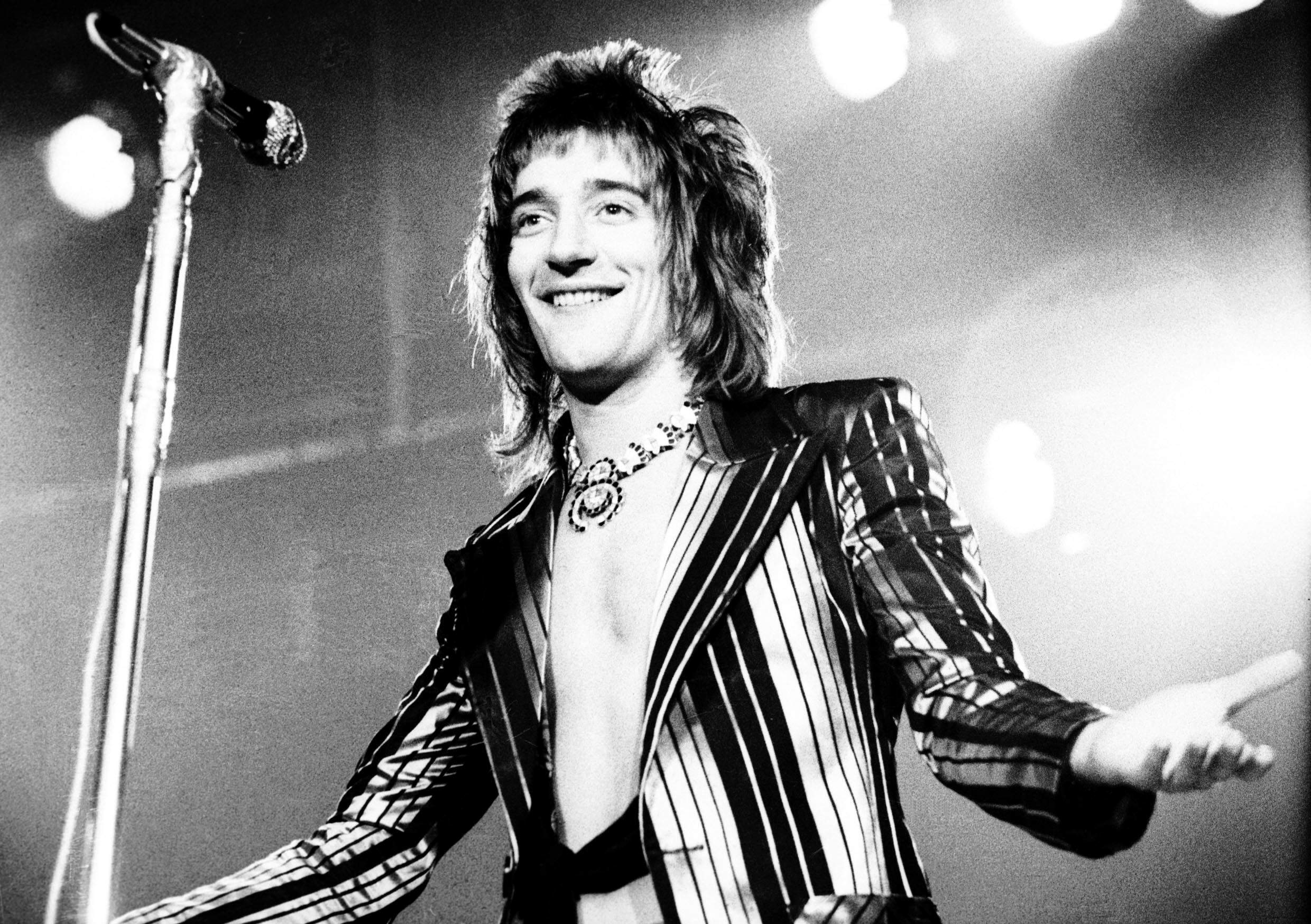 Rod Stewart standing near a microphone