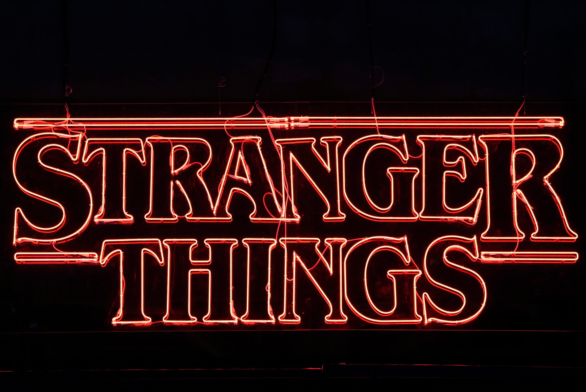 A 'Stranger Things' sign with a black background