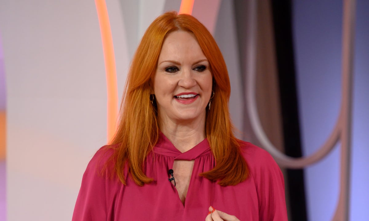 The Pioneer Woman star Ree Drummond, creator of multiple broccoli cheese soup recipes, smiling and wearing a magenta top