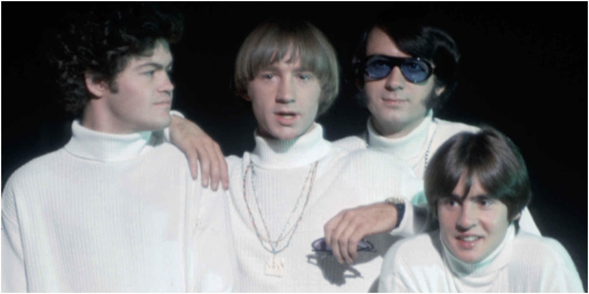 The Monkees dressed in white turtlenecks.