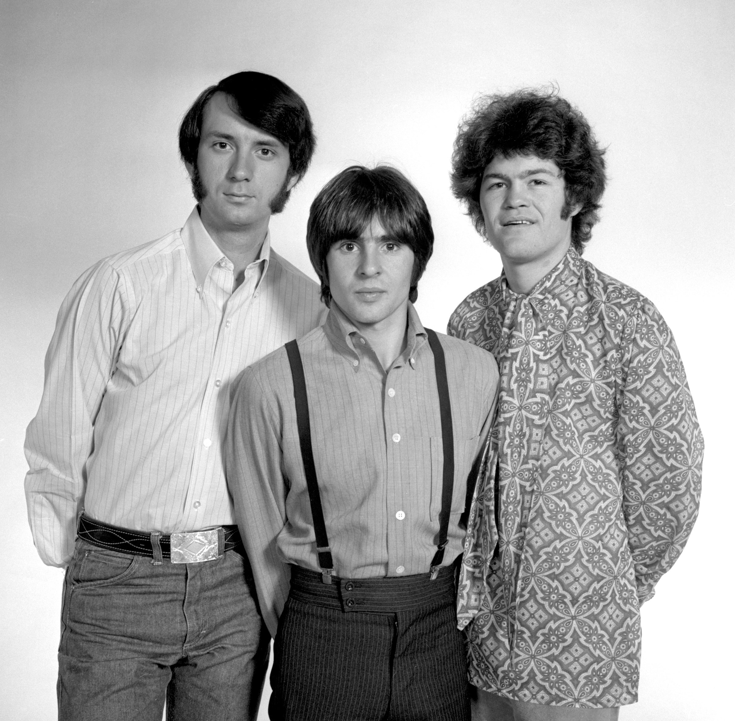 The Monkees' Mike Nesmith, Davy Jones, and Micky Dolenz standing in a row