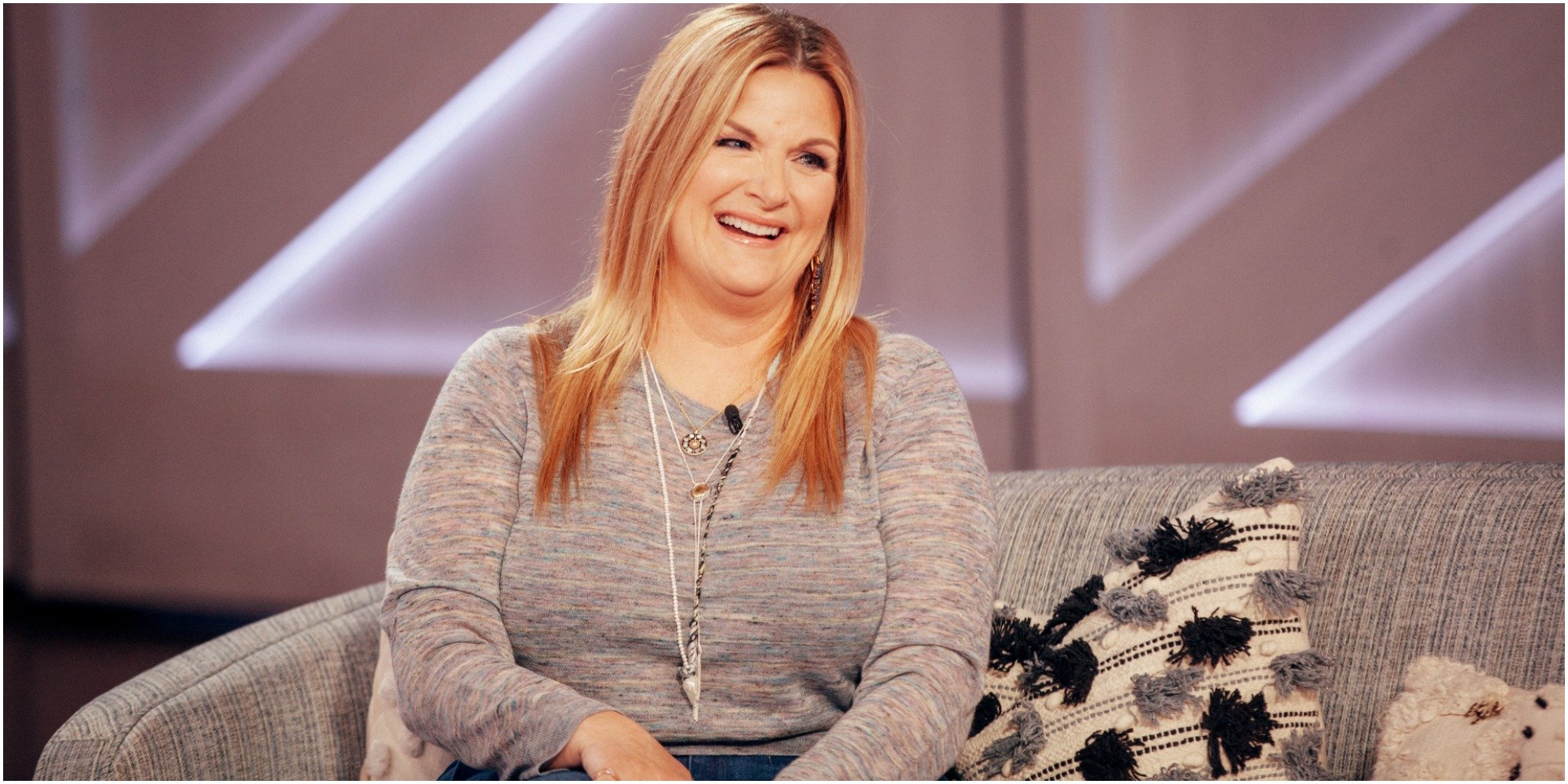 Trisha Yearwood sit on a sofa during an appearance on The Kelly Clarkson Show.