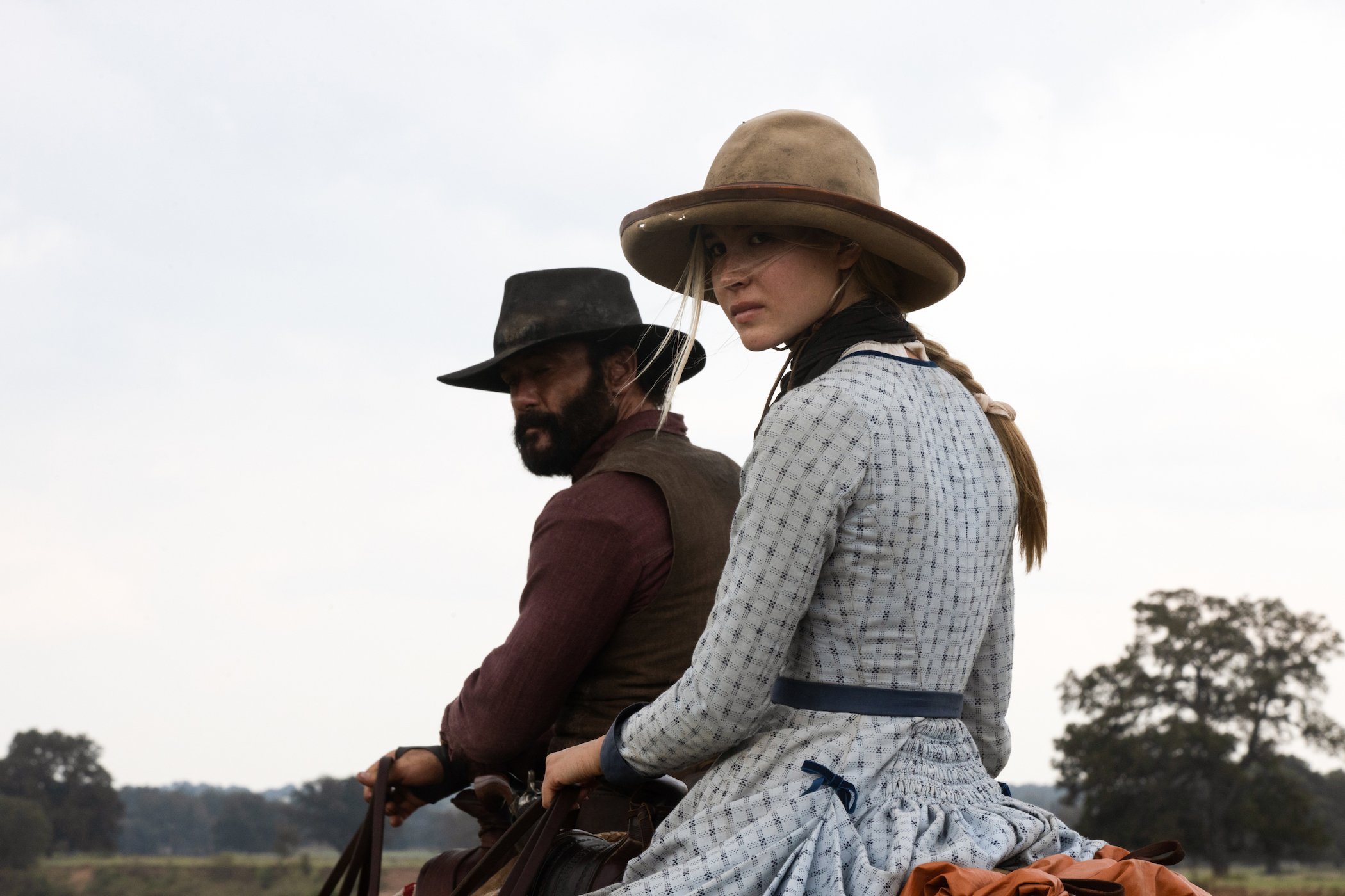 Tim McGraw as James Dutton and Isabel May as Elsa Dutton on horses in '1883'