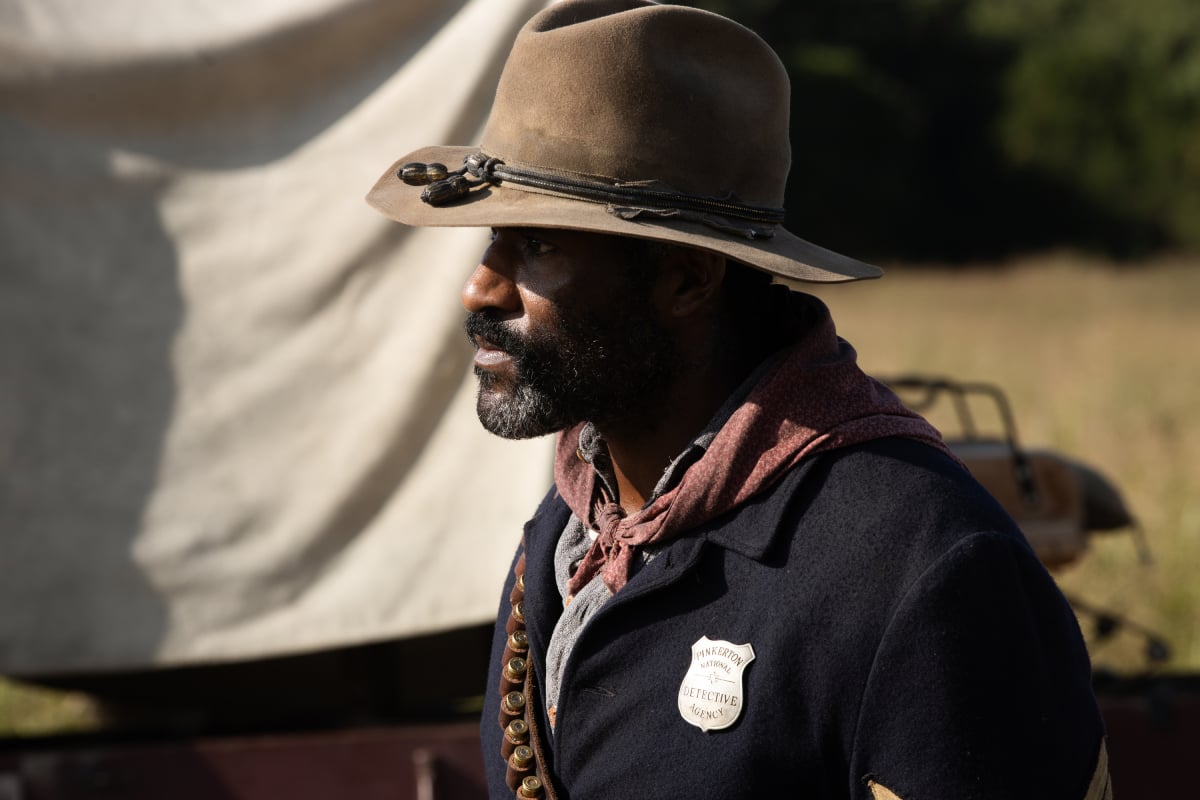 LaMonica Garrett as Thomas of the Paramount+ original series 1883. Thomas wears a badge and a cowboy hat.