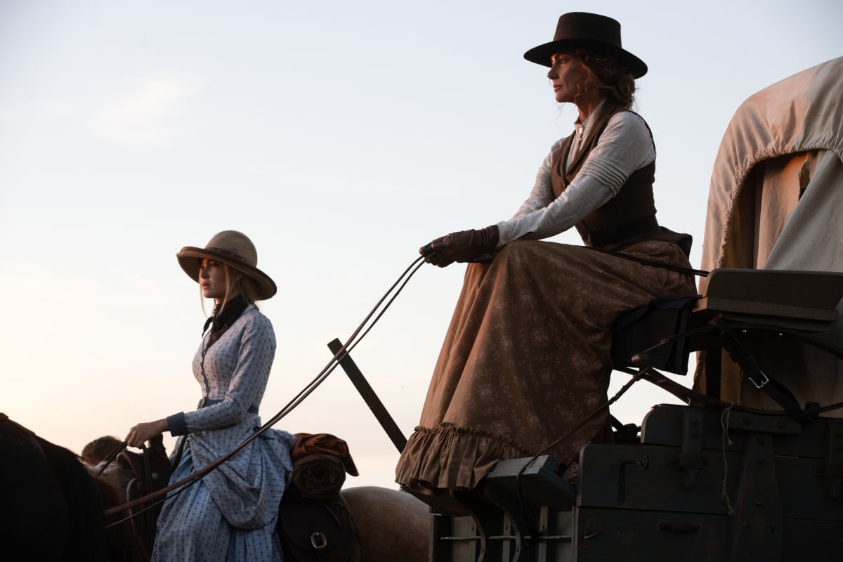 Isabel May as Elsa and Faith Hill as Margaret of the Paramount+ original series 1883. Elsa rides a horse while Margaret sits on the wagon.