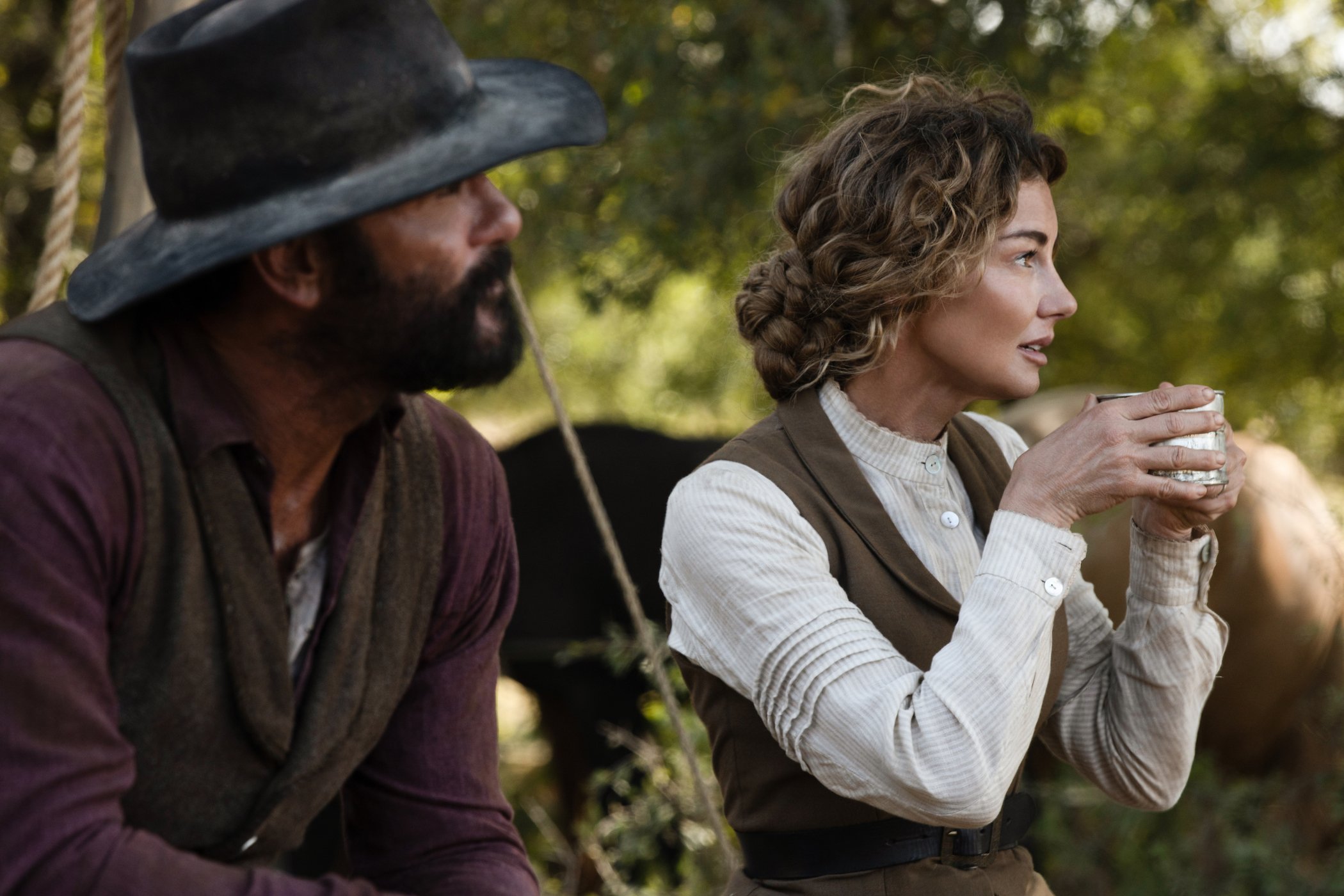 Tim McGraw as James Dutton and Faith Hill as Margaret Dutton sitting next to each other in '1883'